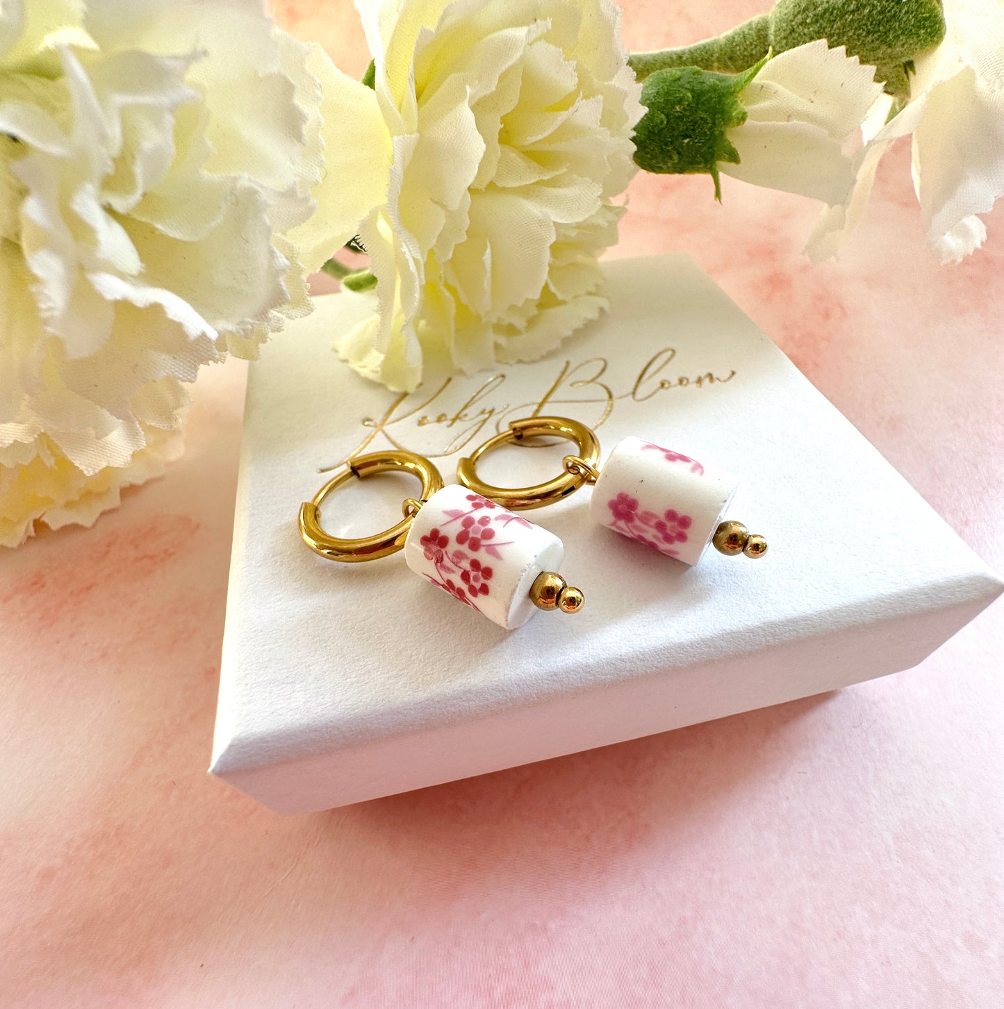 Gold pink floral ceramic bead earrings.