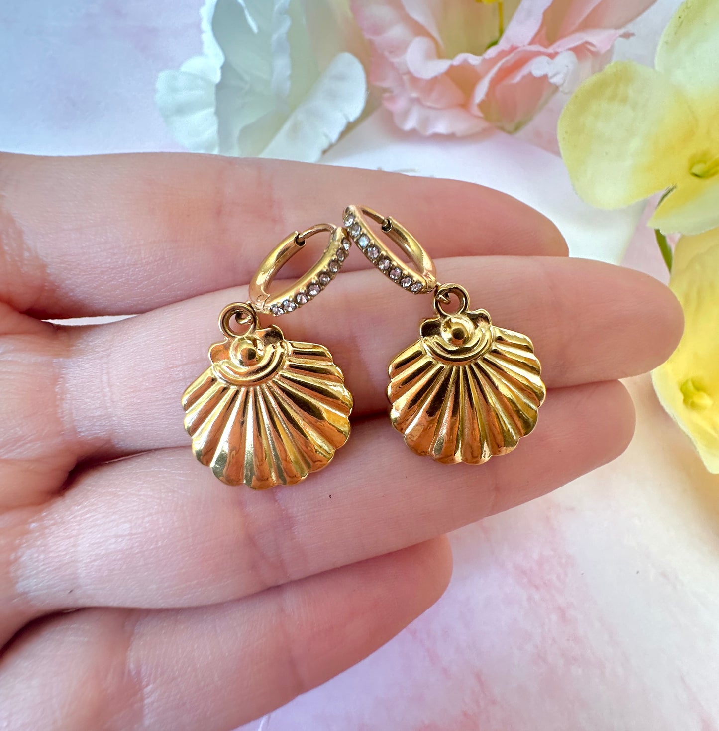 Gold seashell CZ huggie earrings.