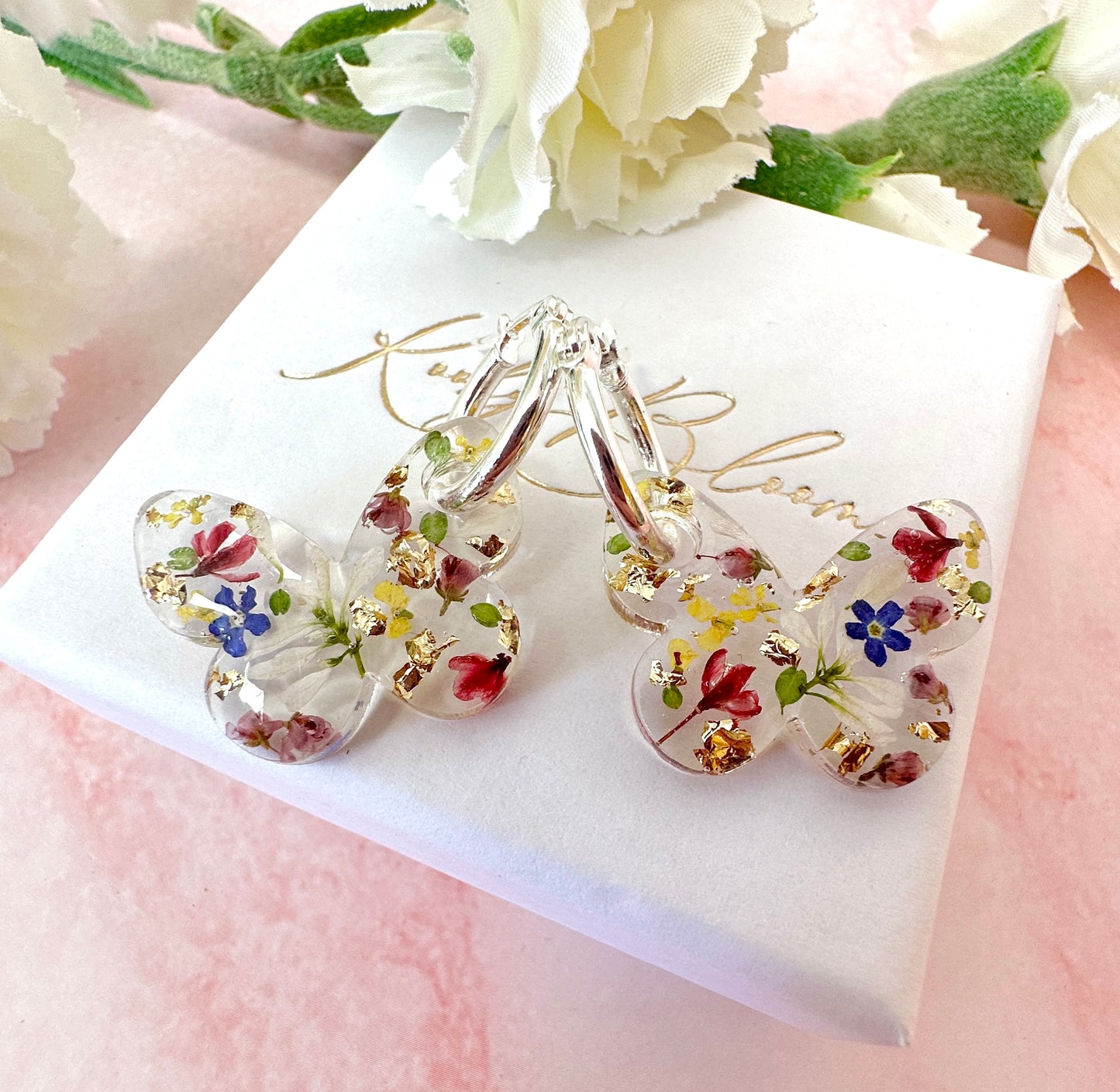 Butterfly flower confetti bloom hoop earrings.
