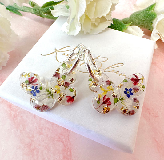 Butterfly flower confetti bloom hoop earrings.