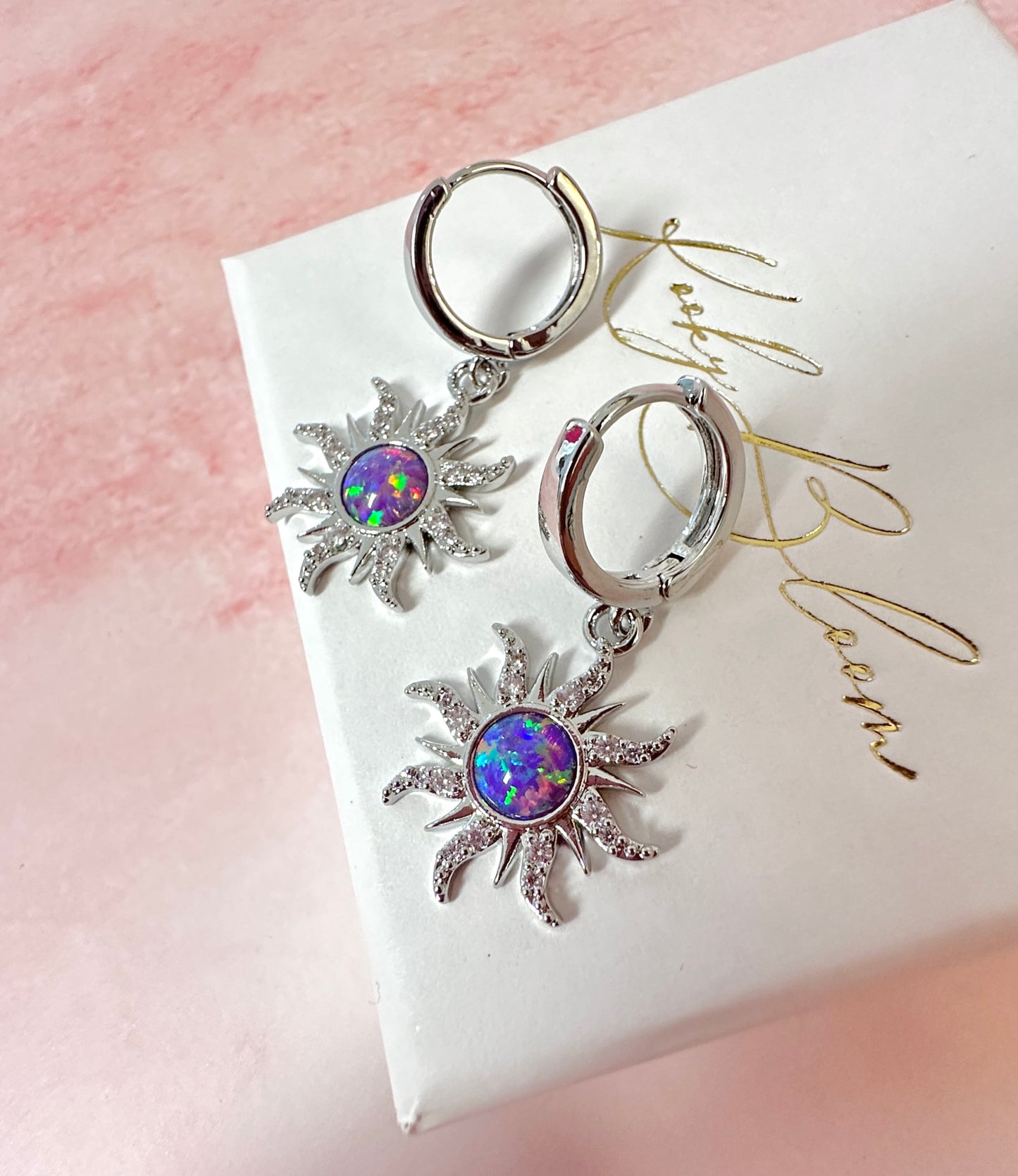 Silver Purple Opal Sun Huggie hoop earrings.