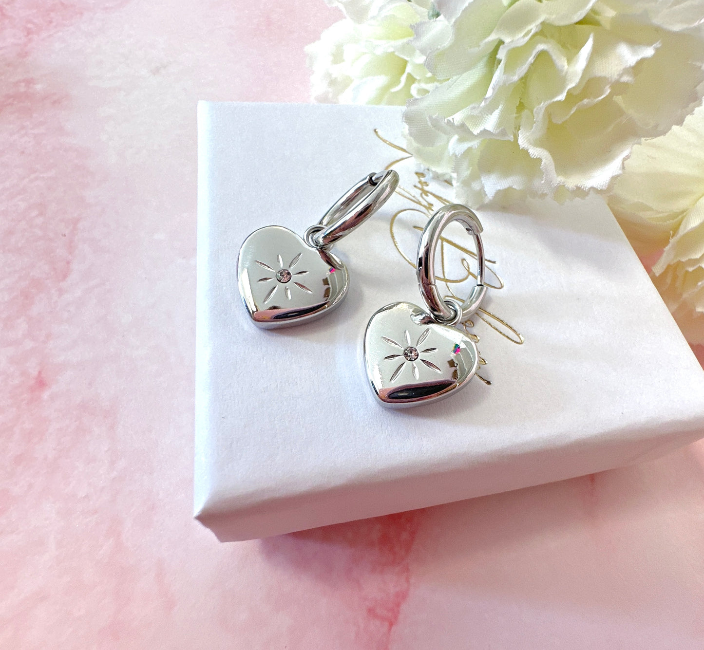 Silver Heart Engraved star Huggie hoop earrings.