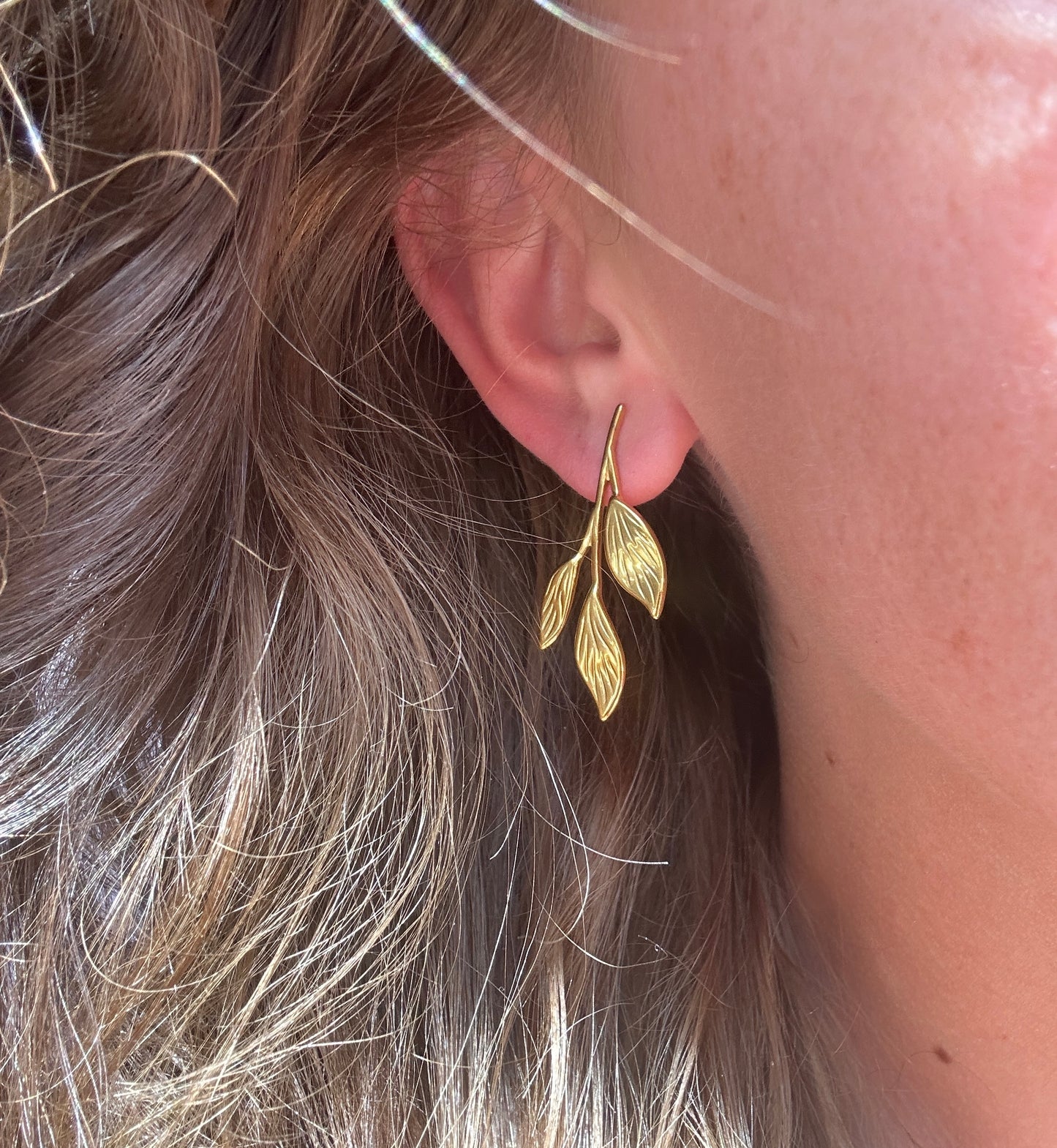Gold vine leaf oversized stud earrings.