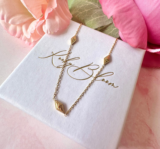 Gold dainty engraved star diamond necklace.