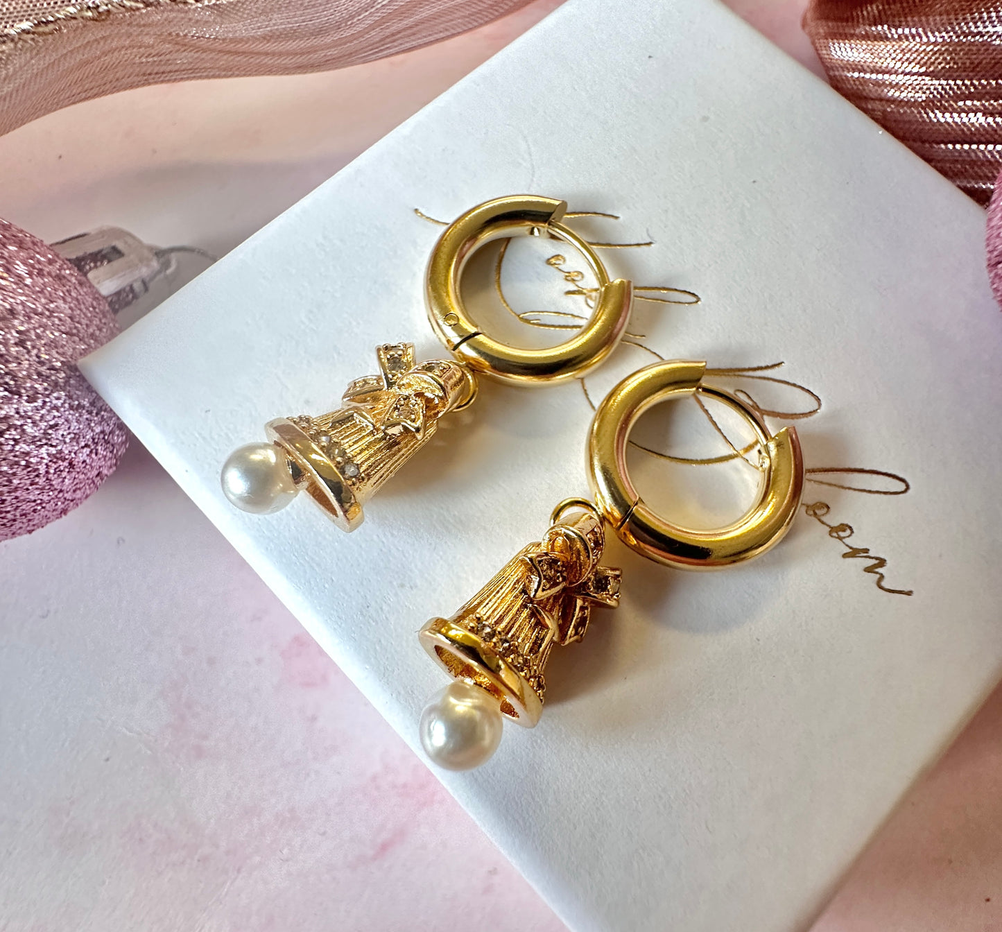Gold Pearl Jingle Bell Huggie hoop earrings.