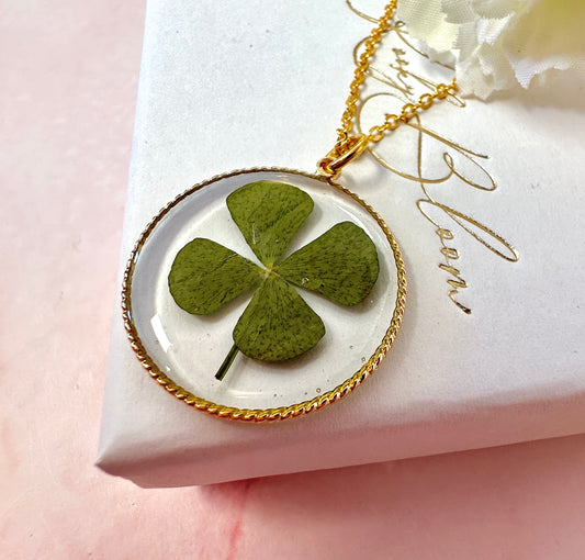Gold lucky four leaf clover necklace.