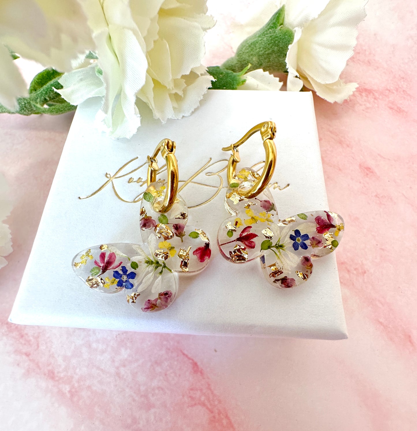 Butterfly flower confetti bloom hoop earrings.