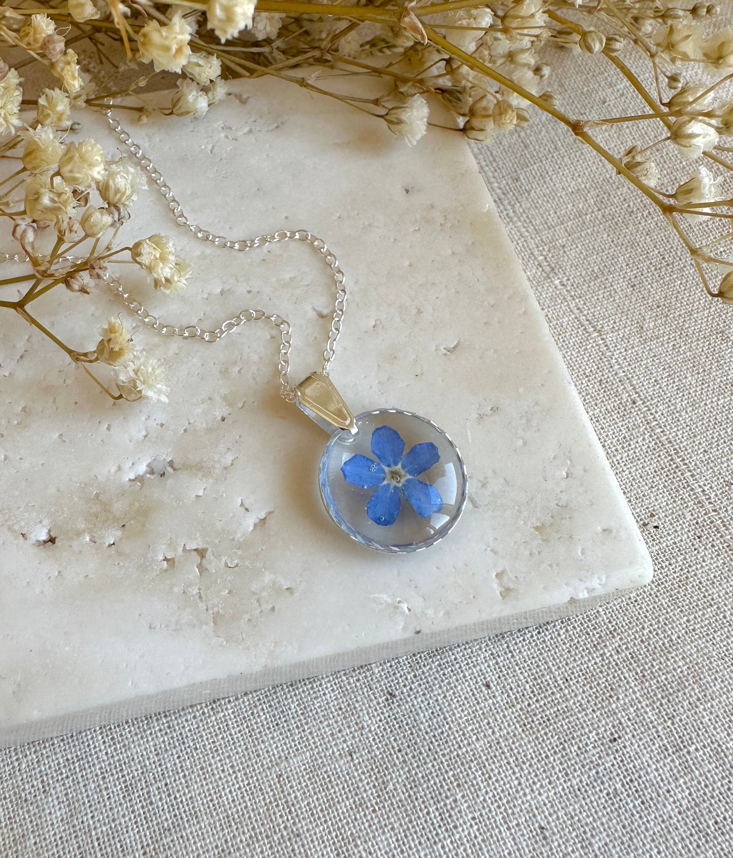 Real forget me not flower silver necklace.