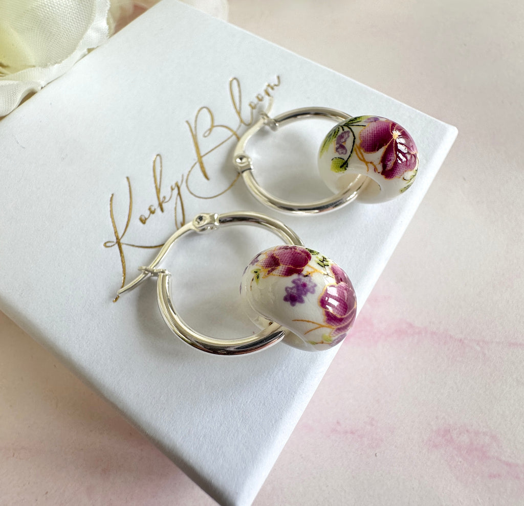 Silver Purple floral ceramic bead hoop earrings.