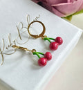 Cherry huggie earrings.