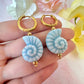 Blue ceramic seashell hoop earrings.