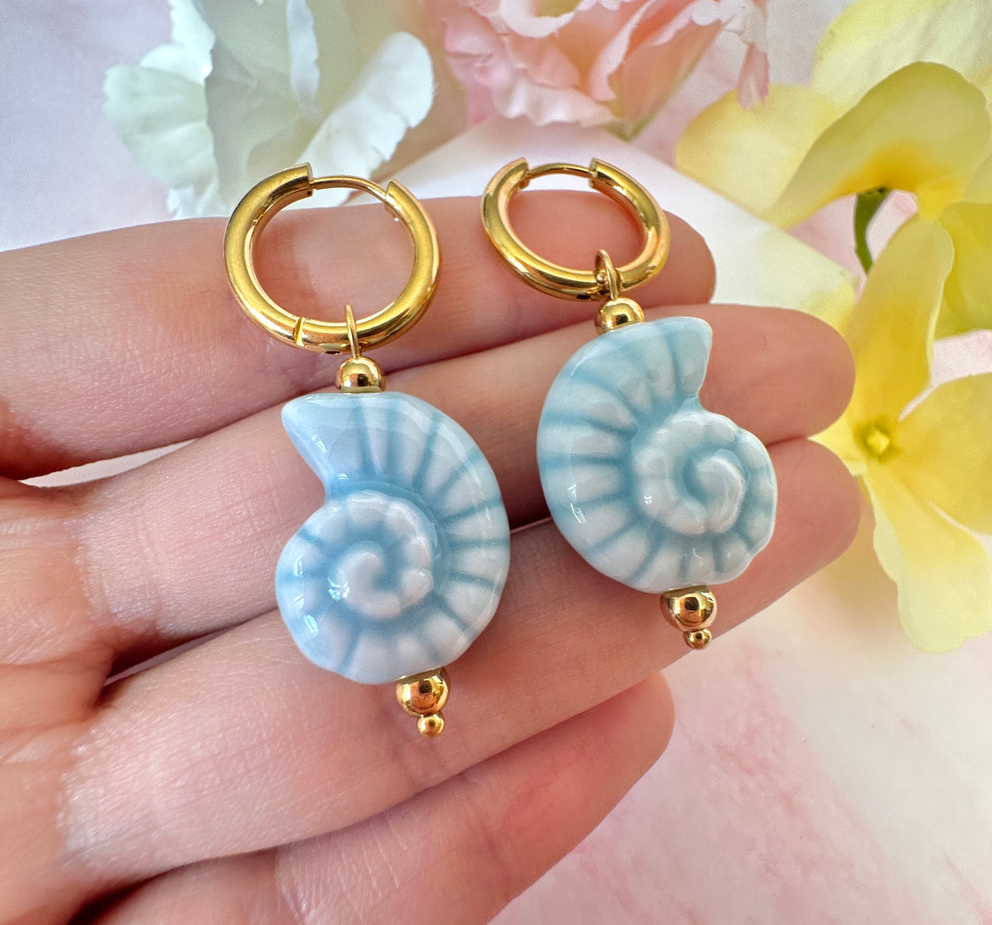 Blue ceramic seashell hoop earrings.