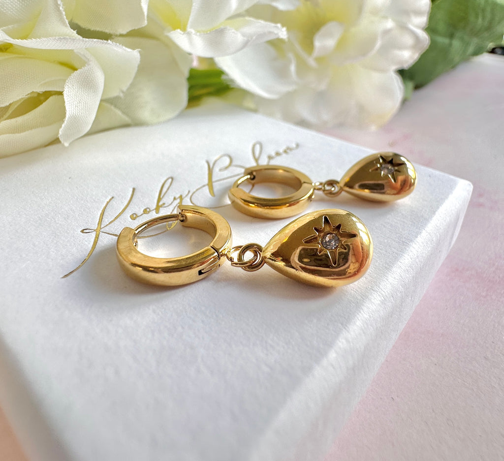 Gold teardrop cz huggie hoop earrings.