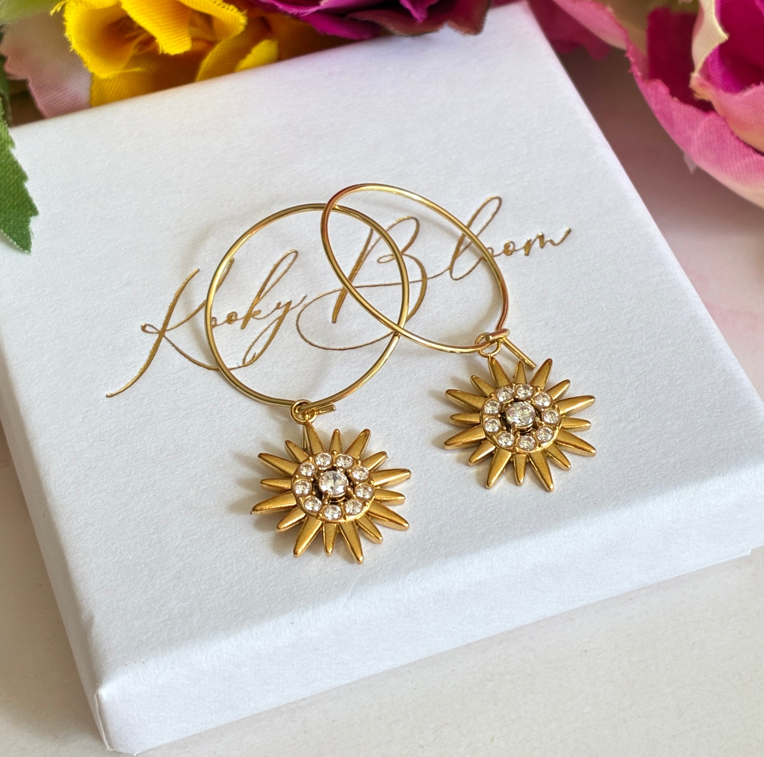 Gold CZ Star sun ray earrings.