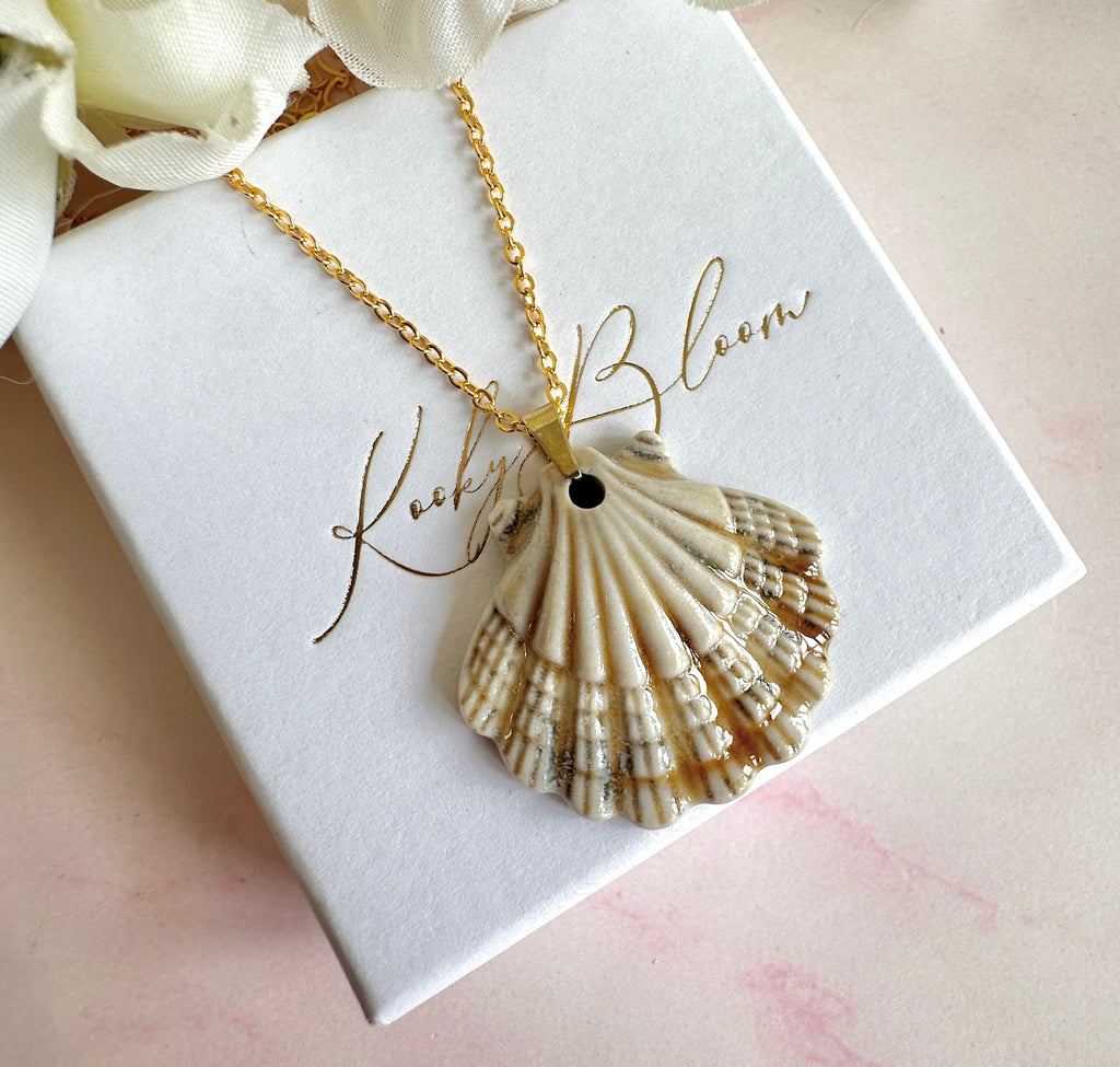 Gold ceramic seashell necklace.