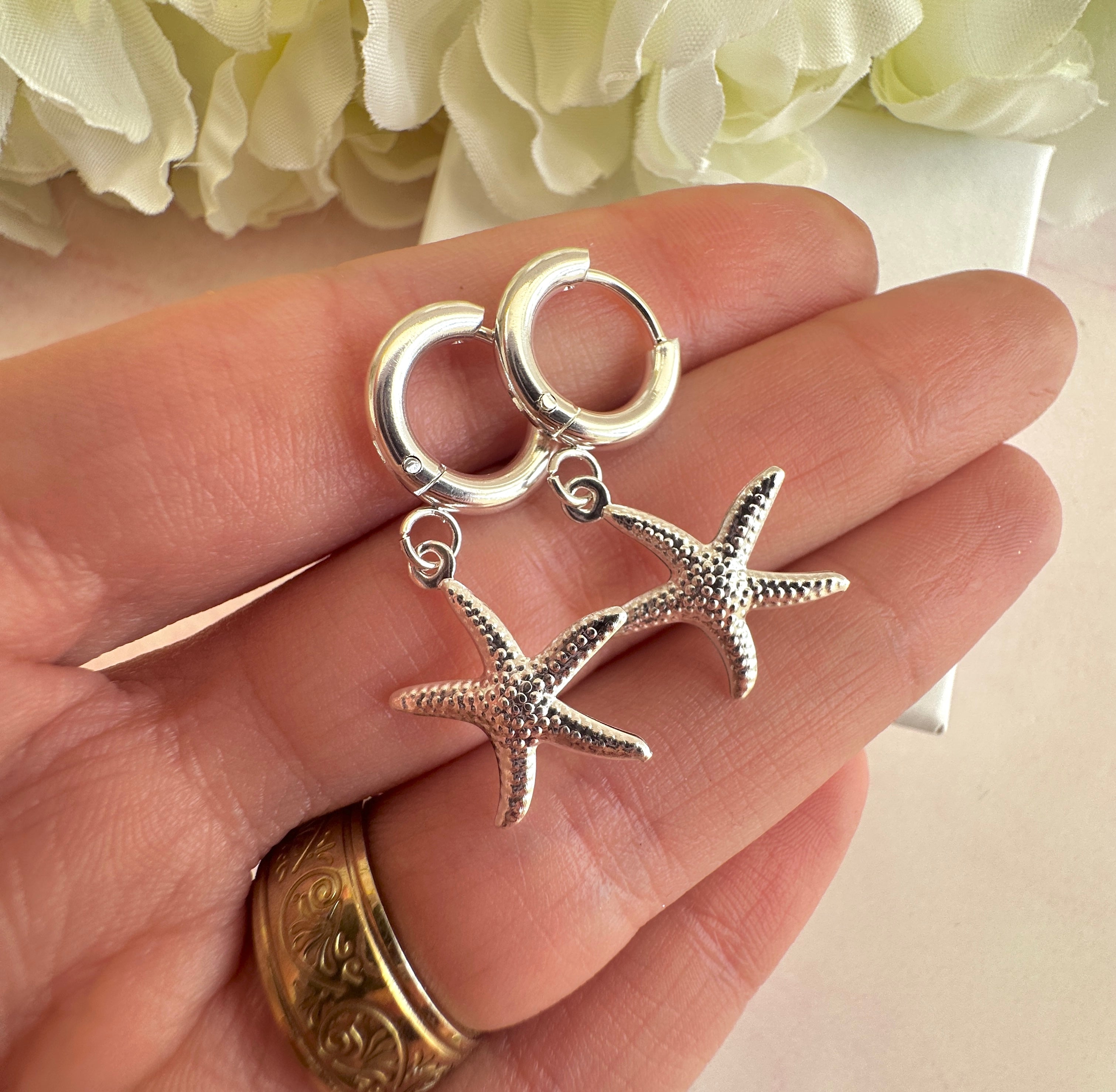 Silver starfish chunky Huggie hoop earrings.