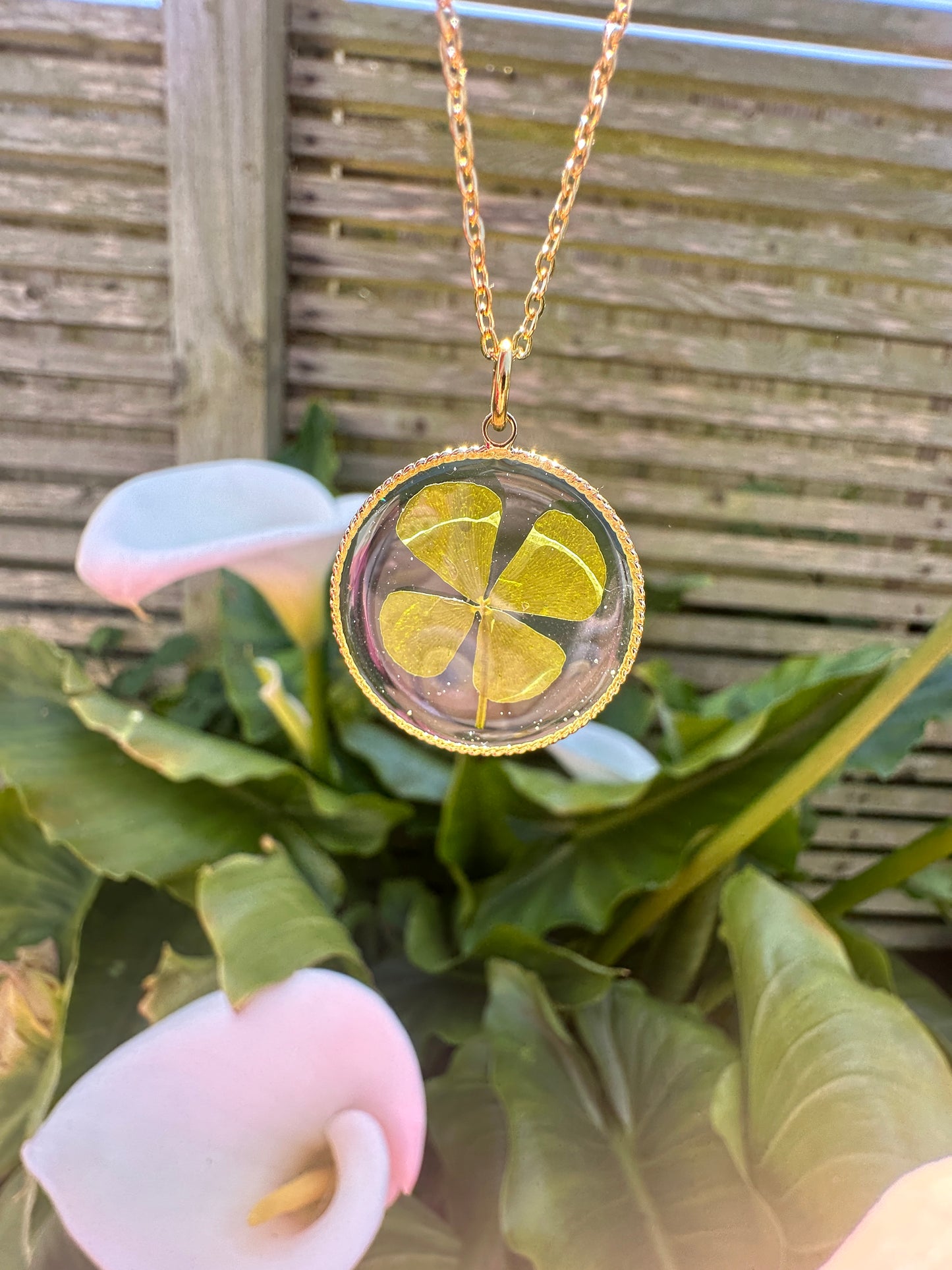 Gold lucky four leaf clover necklace.