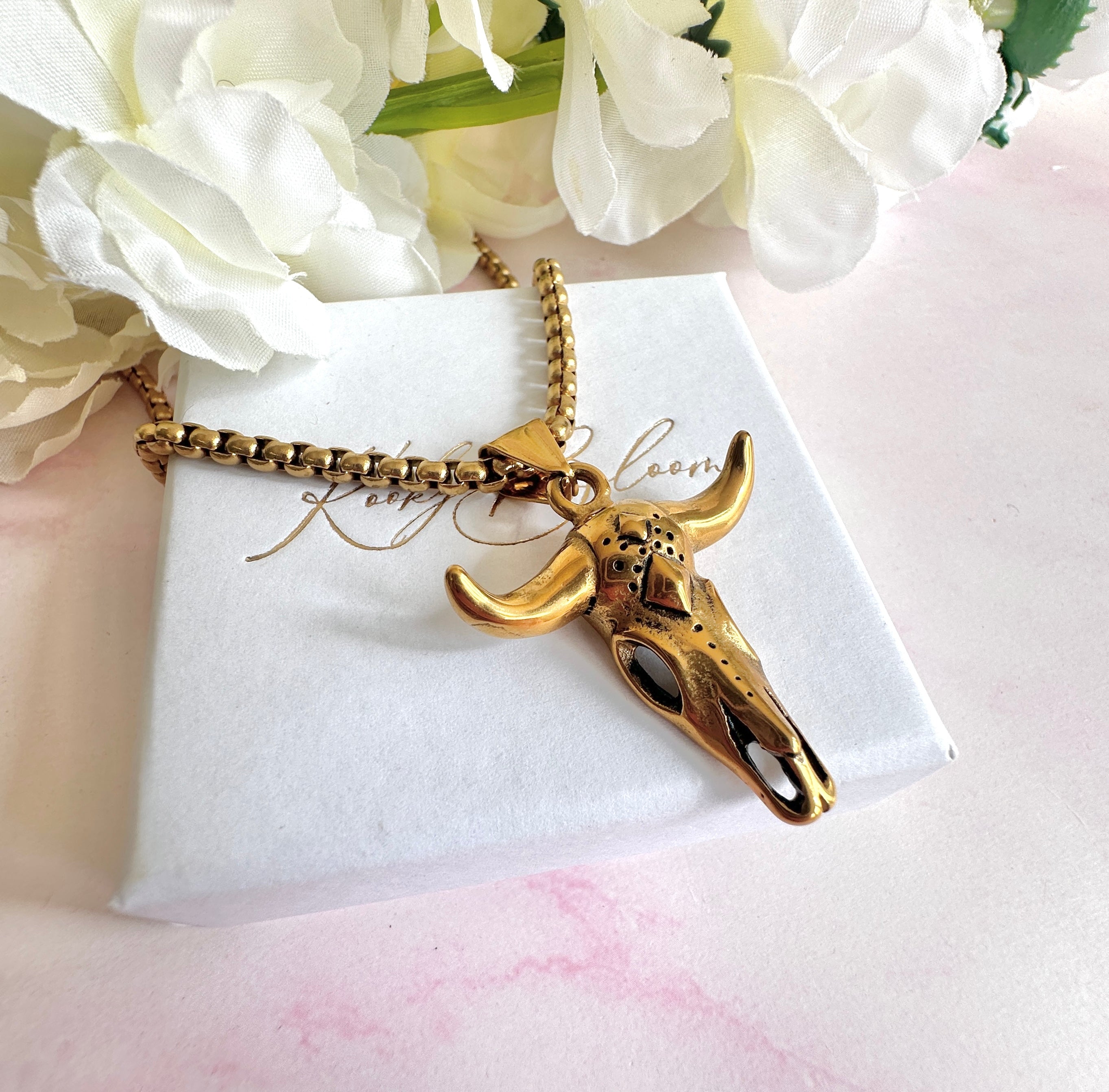 Gold longhorn necklace.