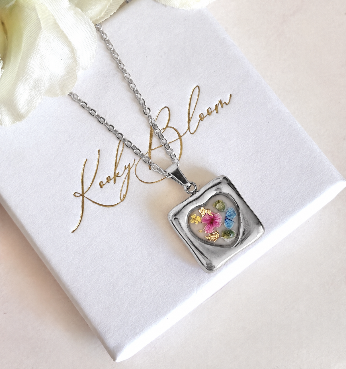 Silver Meadow mosaic heart bloom necklace.