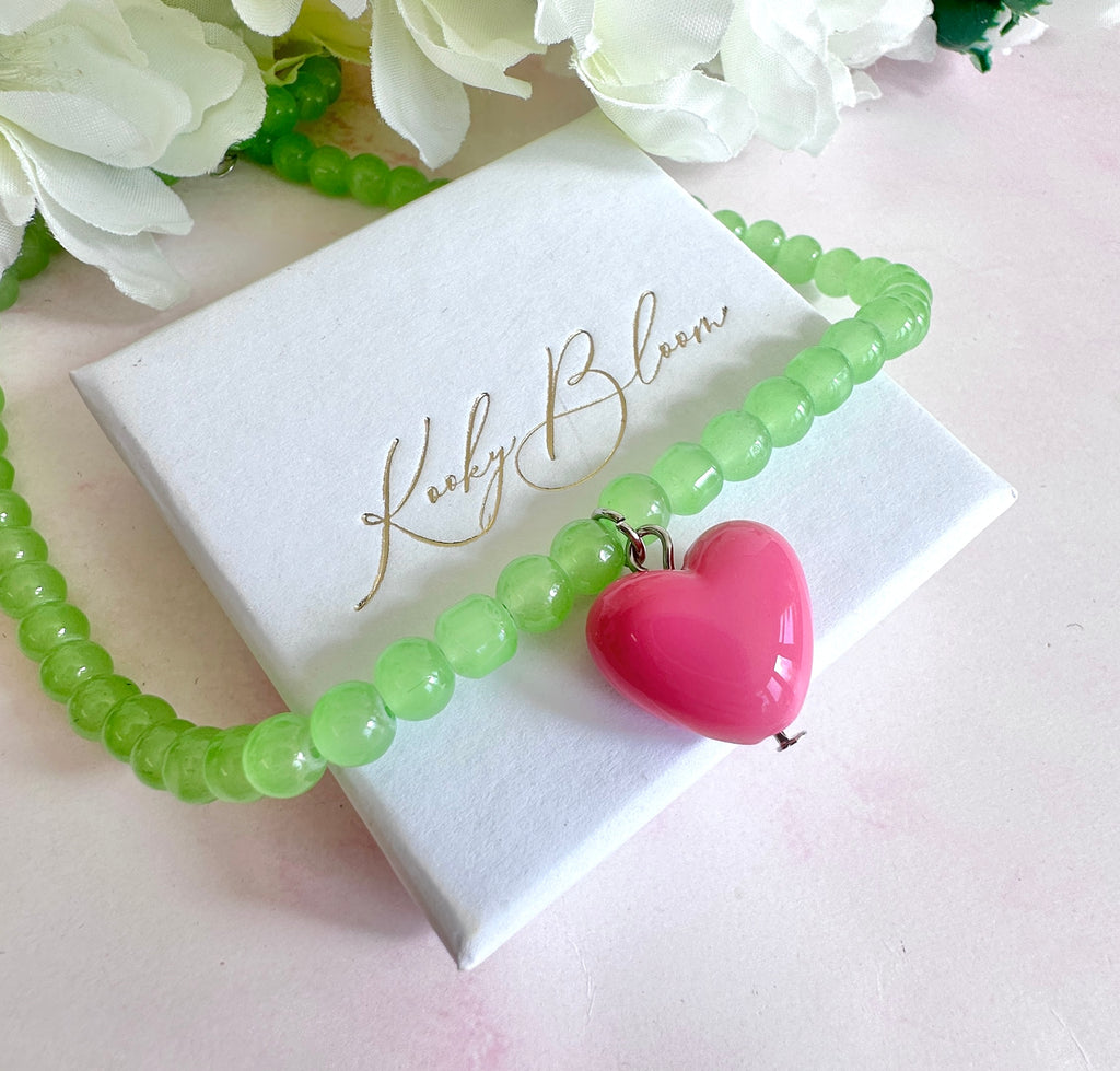 Glass green beaded pink heart necklace.