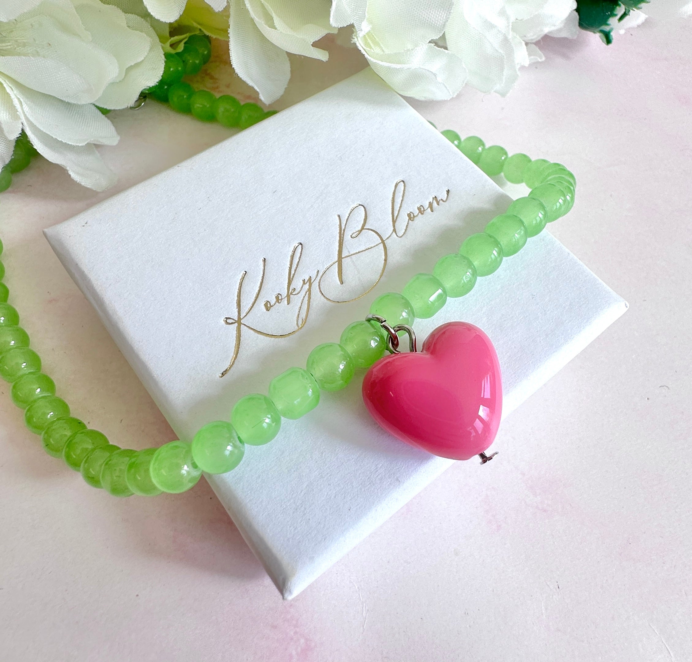 Glass green beaded pink heart necklace.