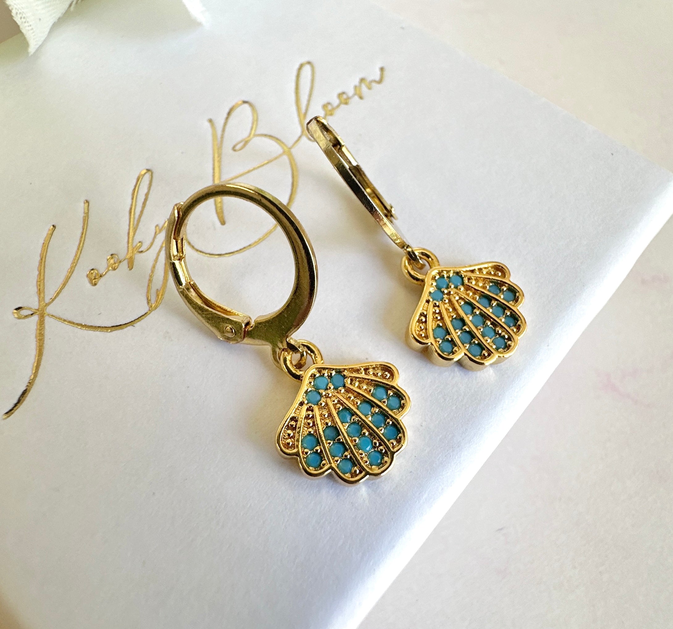 Gold Tiny Blue stone seashell huggie earrings.