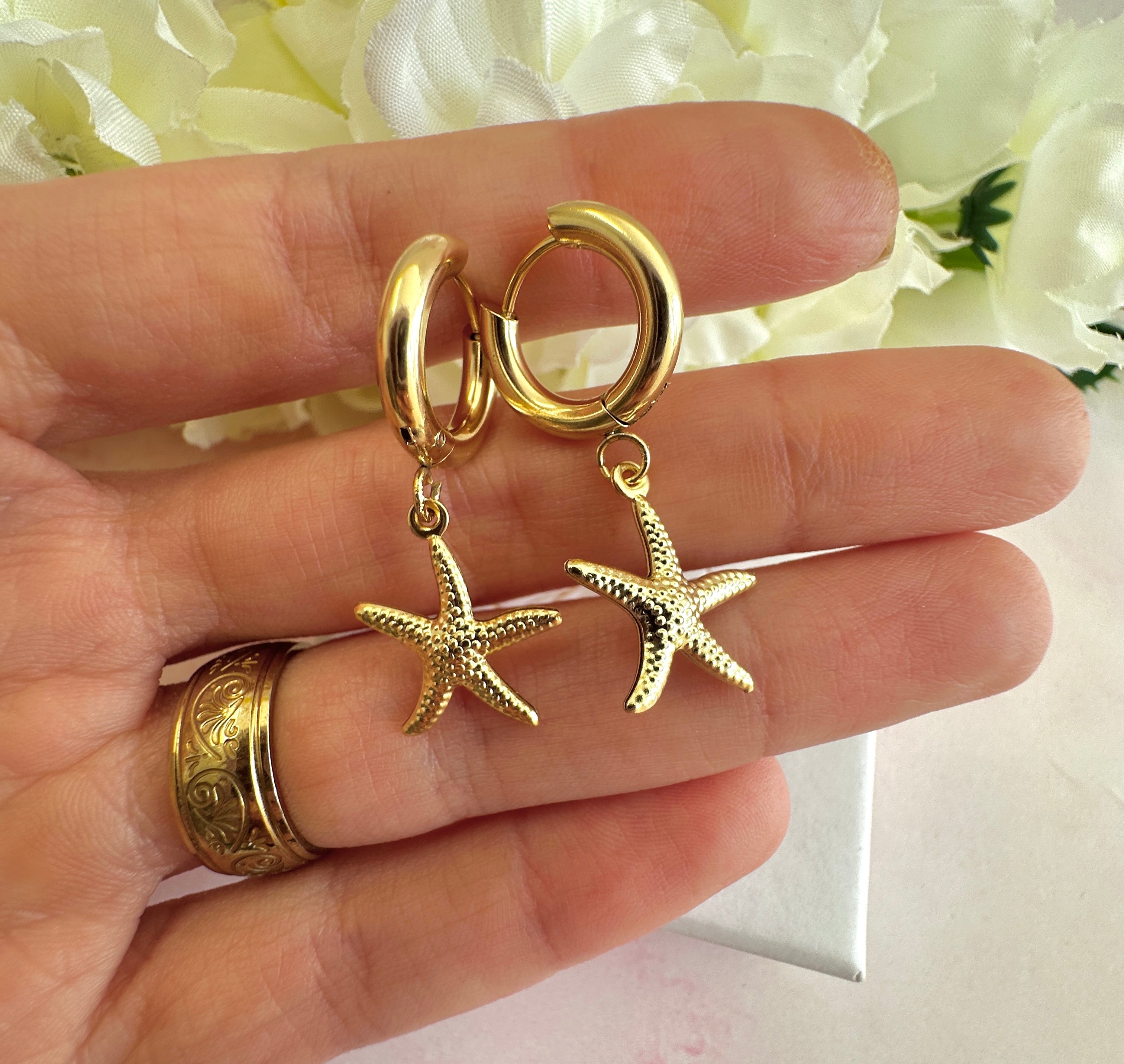 Gold starfish chunky Huggie hoop earrings.