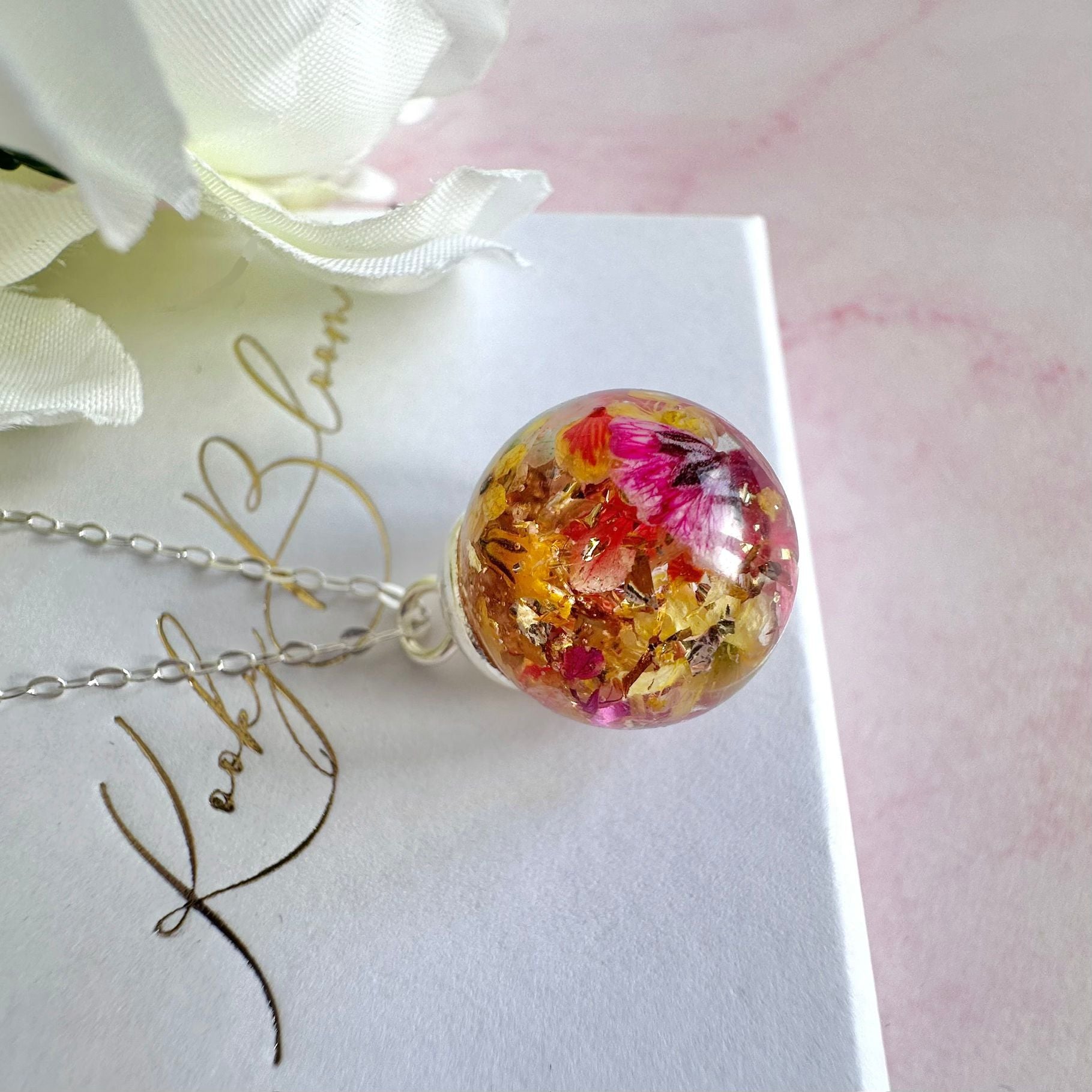 Silver Flower confetti Globe necklace.