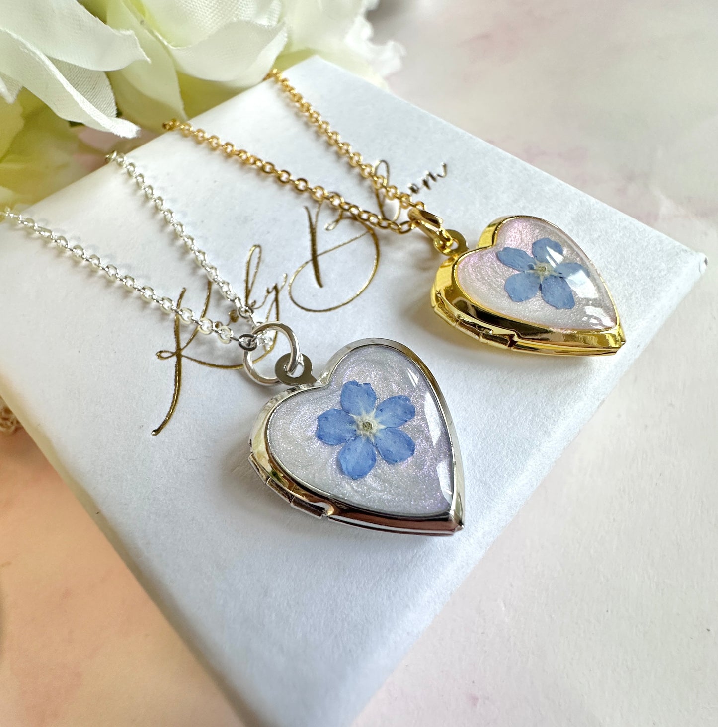 Silver Forget me not flower heart locket necklace.