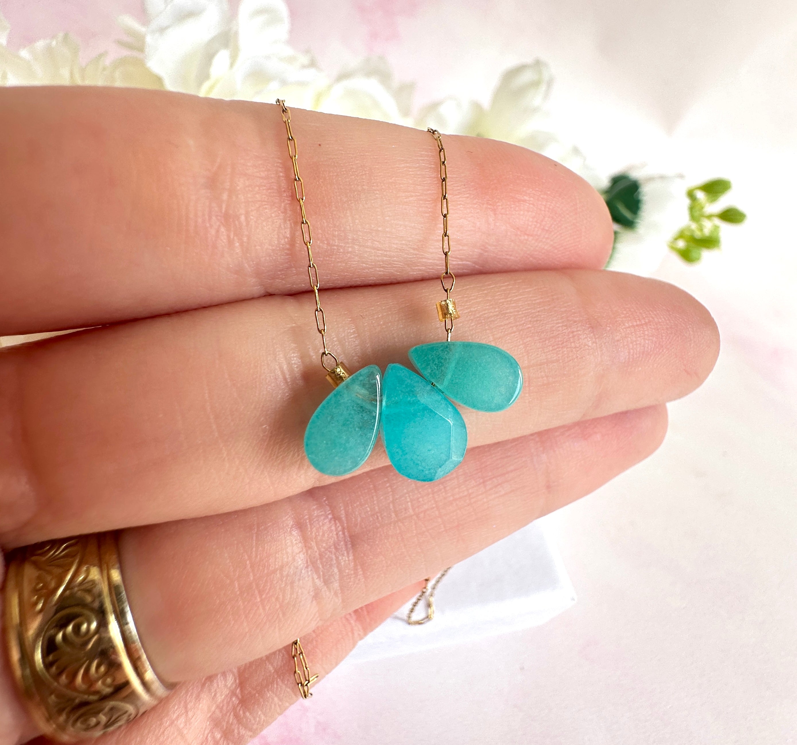 Gold triple aqua gemstone necklace.