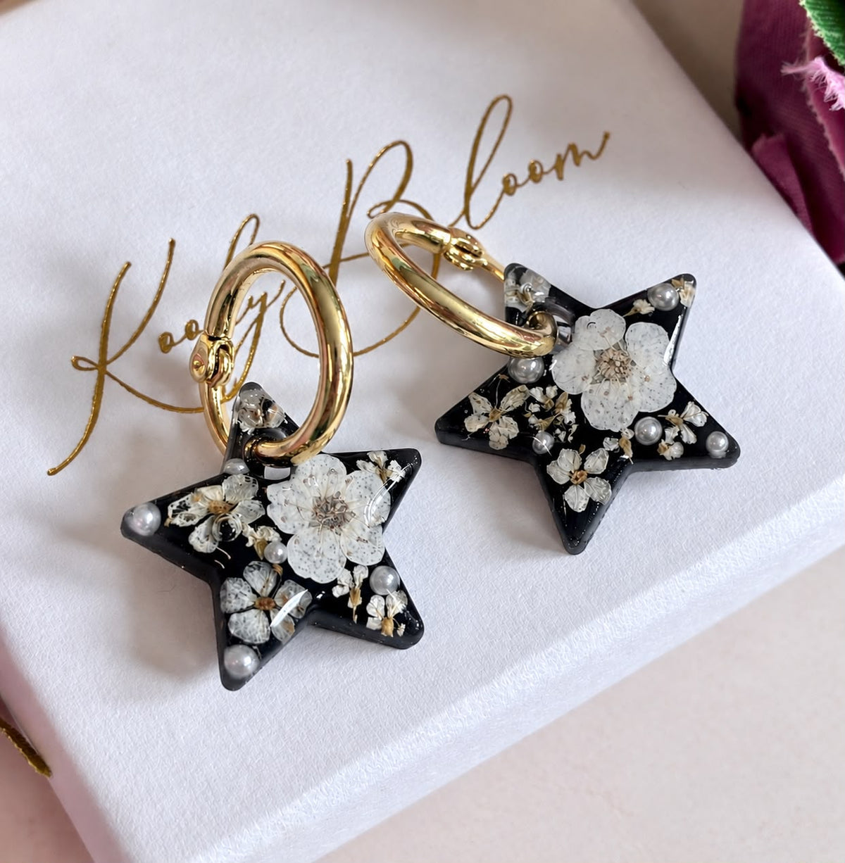 Midnight Pearl Star bloom hoop earrings.