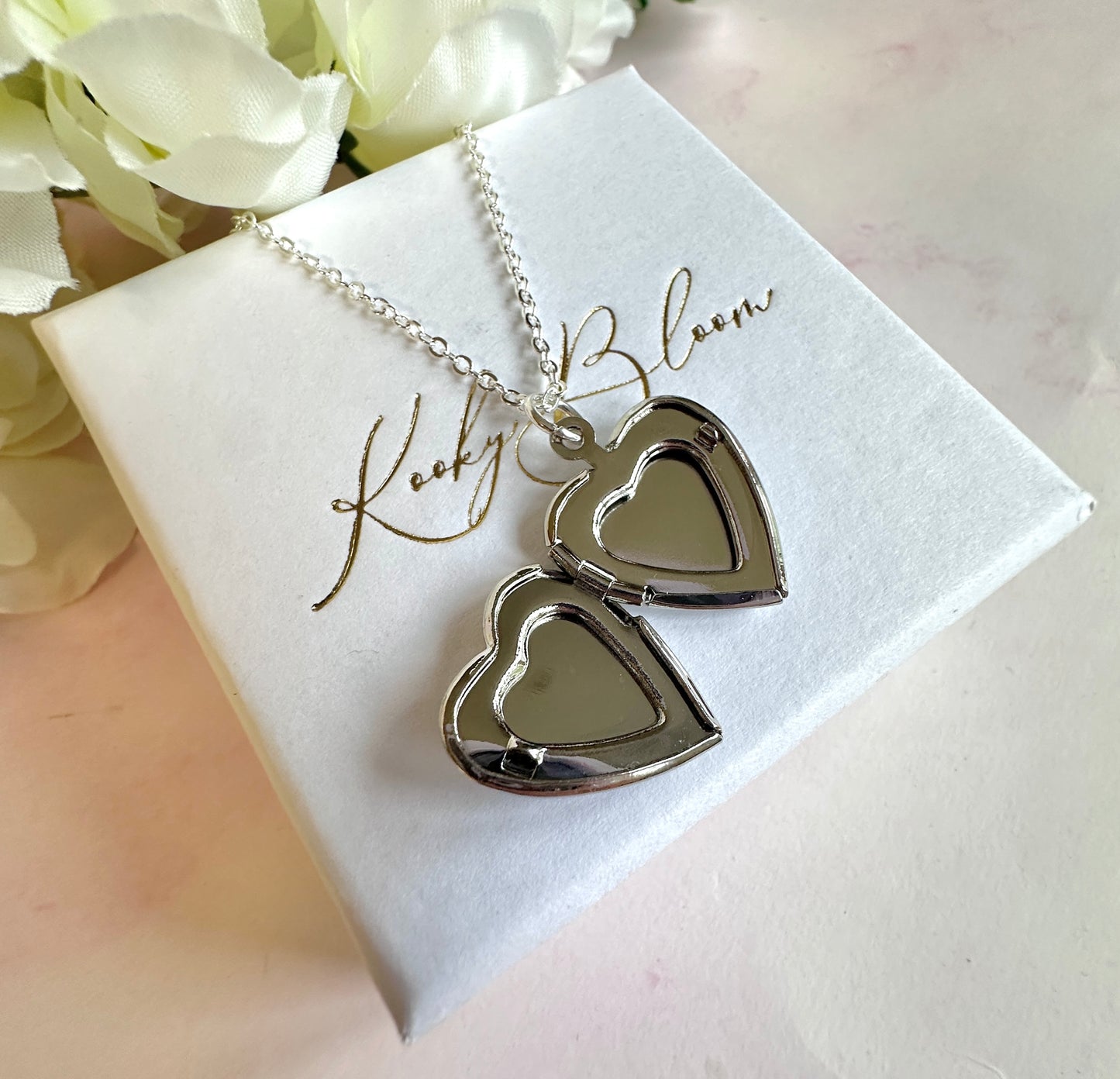 Silver Forget me not flower heart locket necklace.