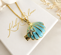 Gold Blue enamel Seashell locket necklace.