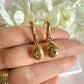 Gold teardrop cz huggie hoop earrings.