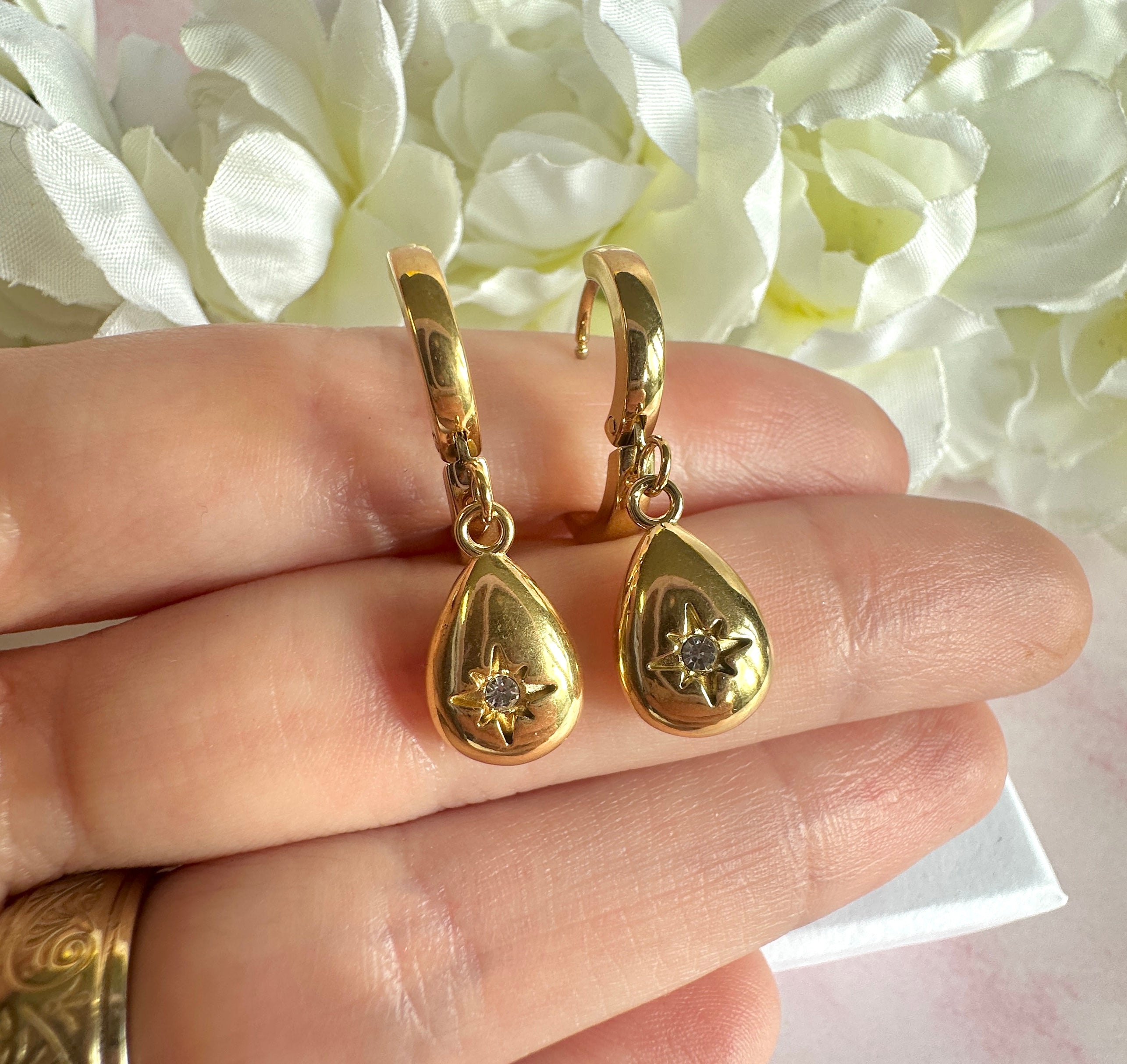 Gold teardrop cz huggie hoop earrings.