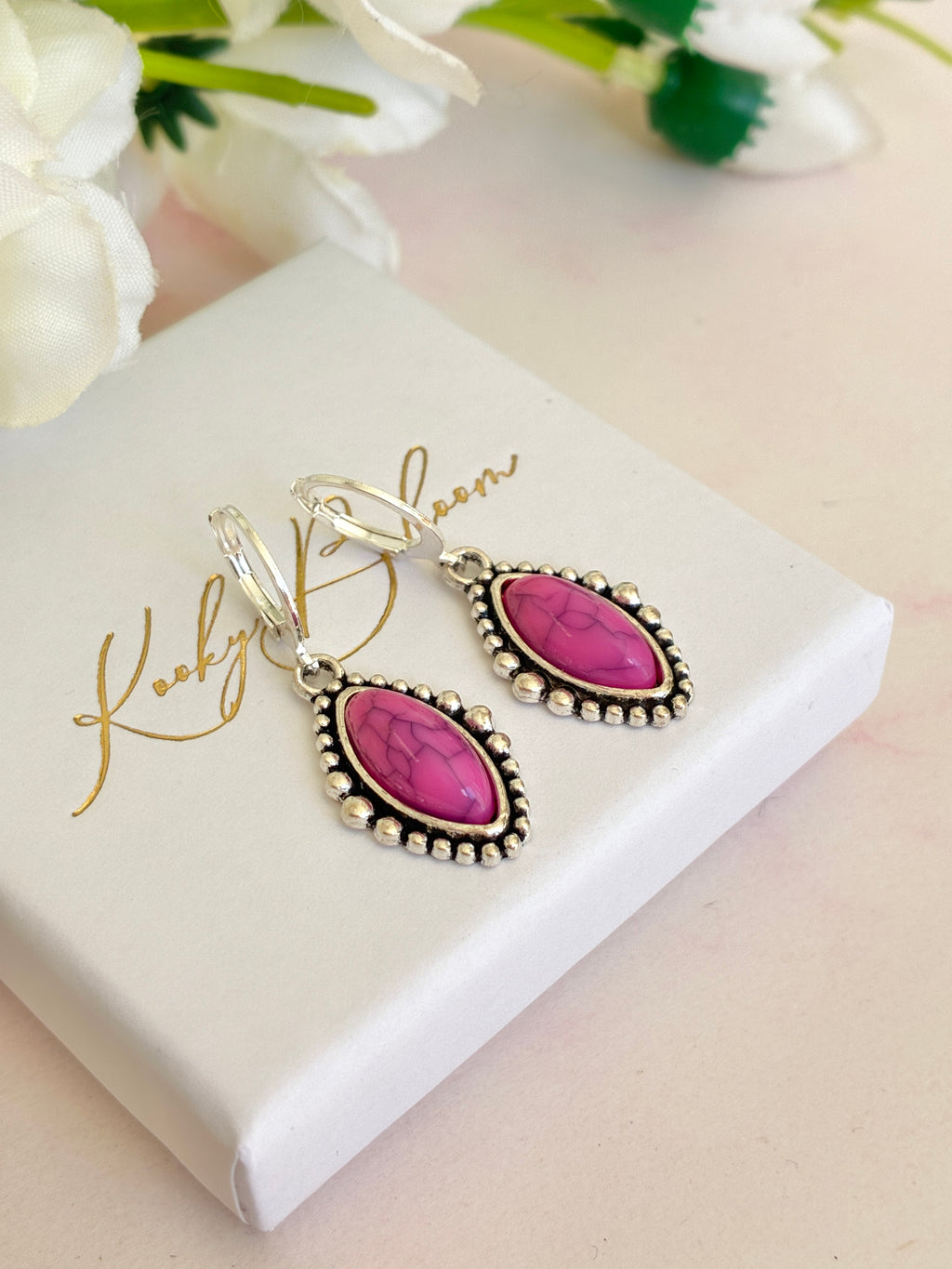 Silver Pink stone horse eye huggie earrings.