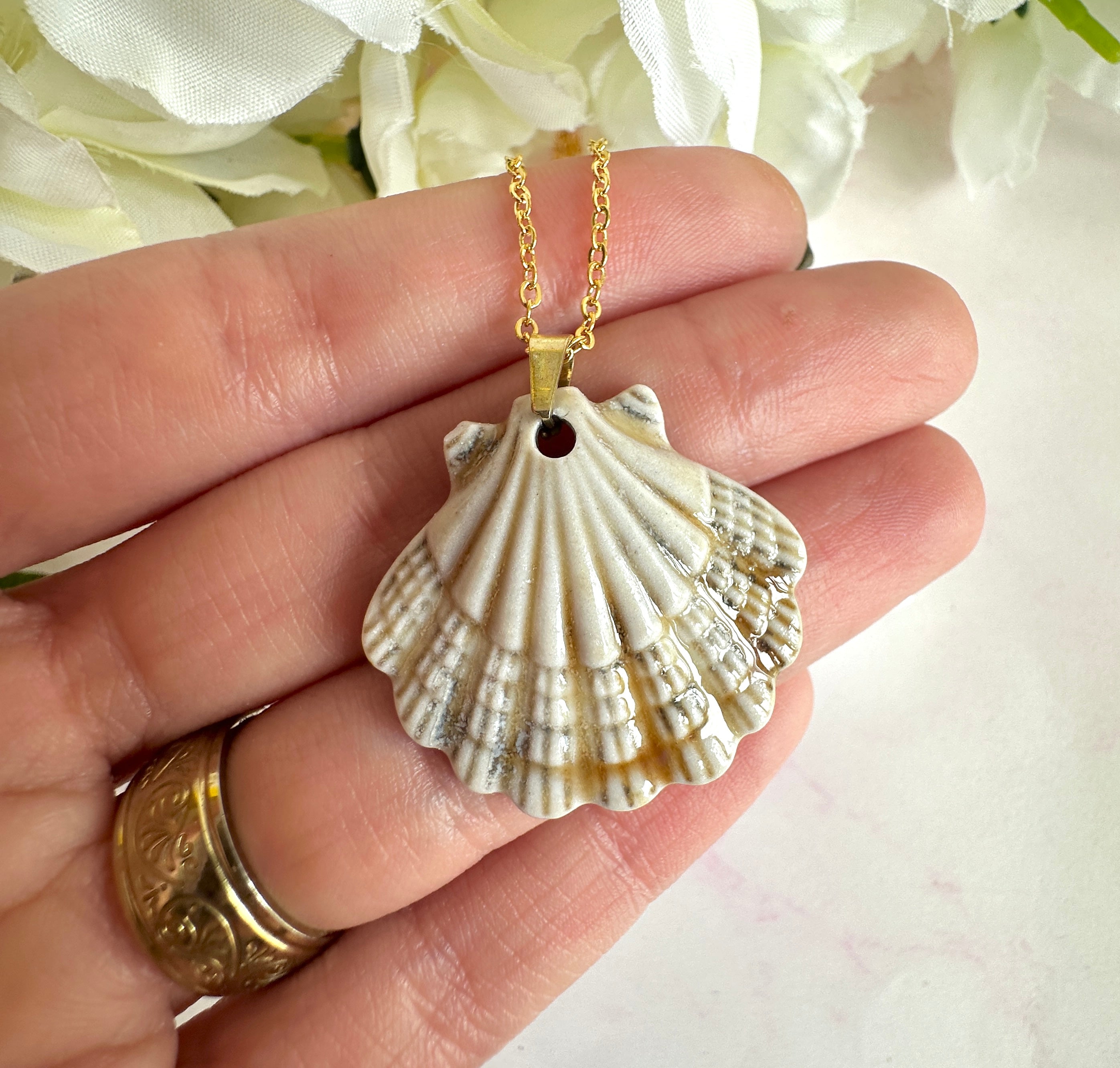 Gold ceramic seashell necklace.