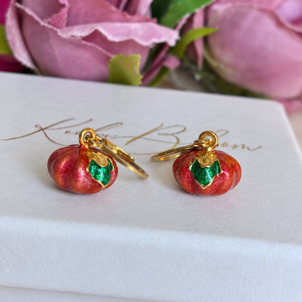 Gold metallic pumpkin huggie earrings.