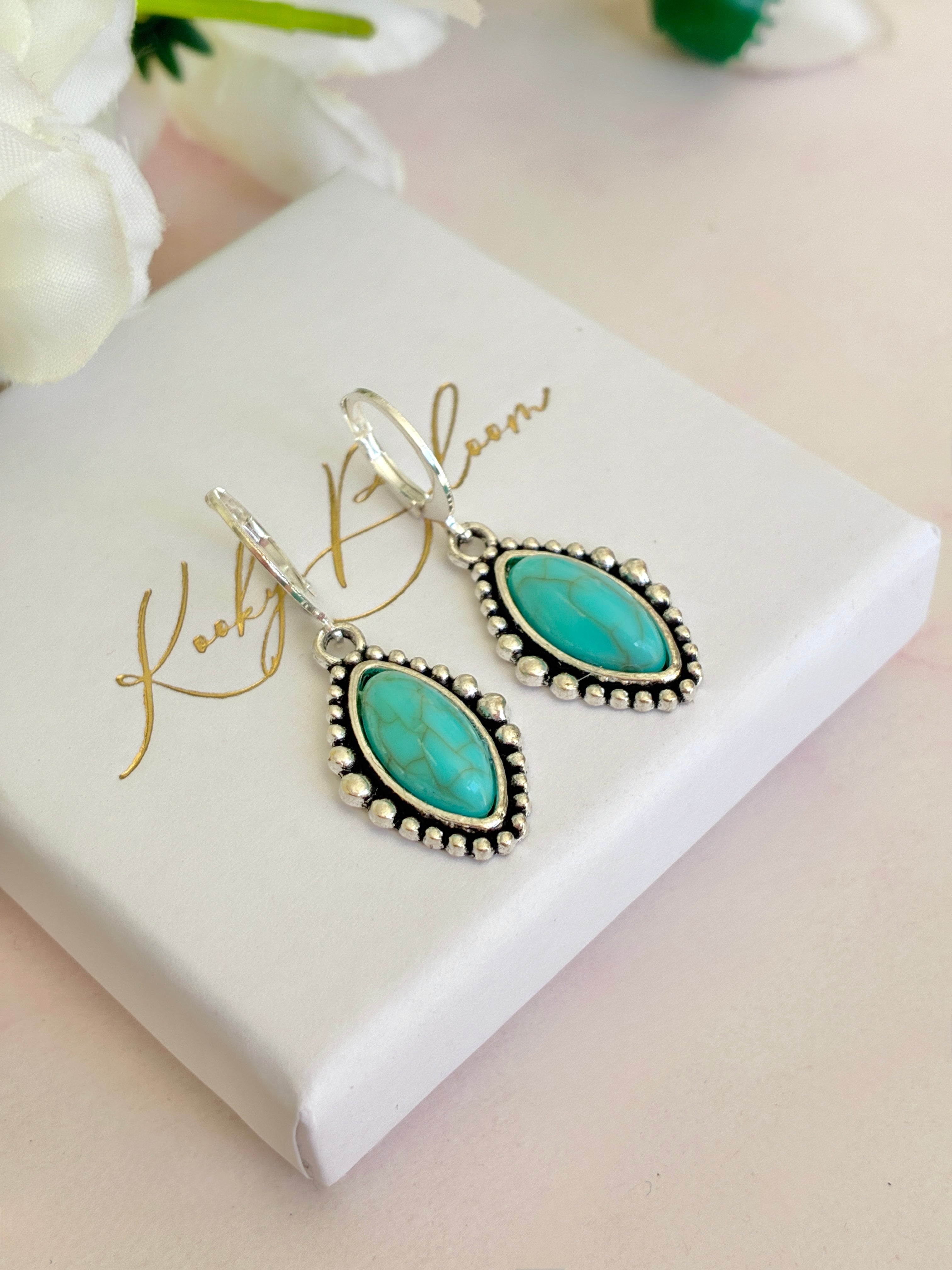 Silver Turquoise stone horse eye huggie earrings.