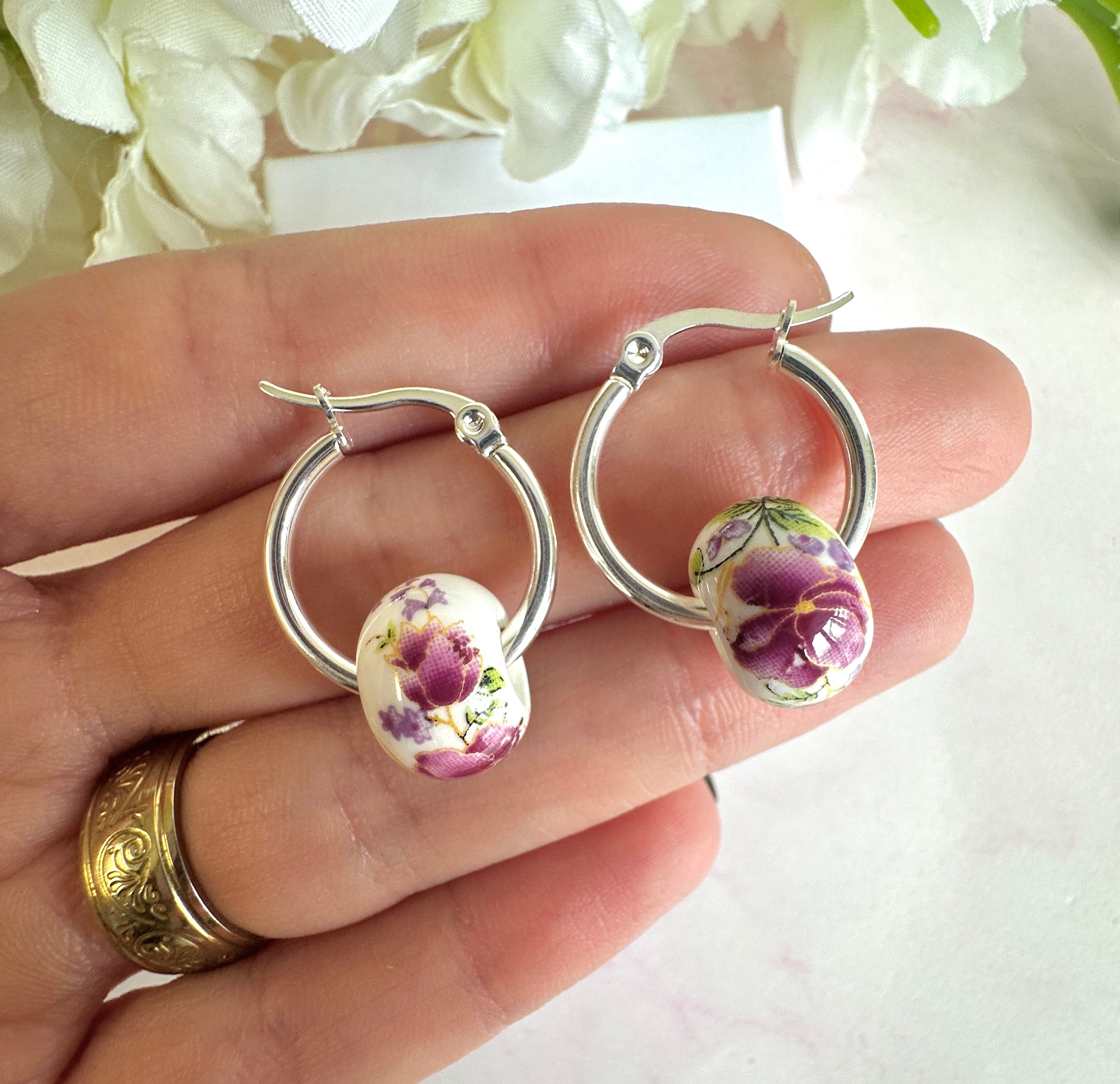 Silver Purple floral ceramic bead hoop earrings.