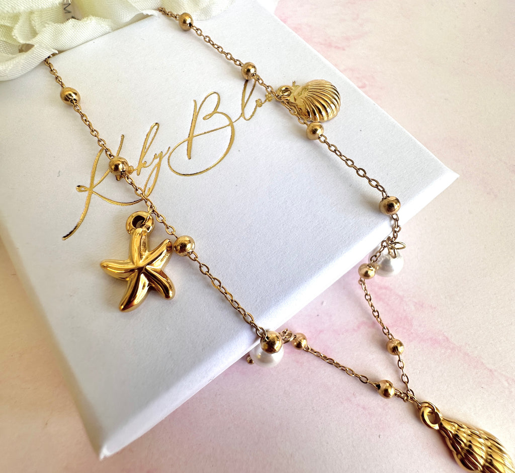 Gold seashell starfish pearl charm necklace.