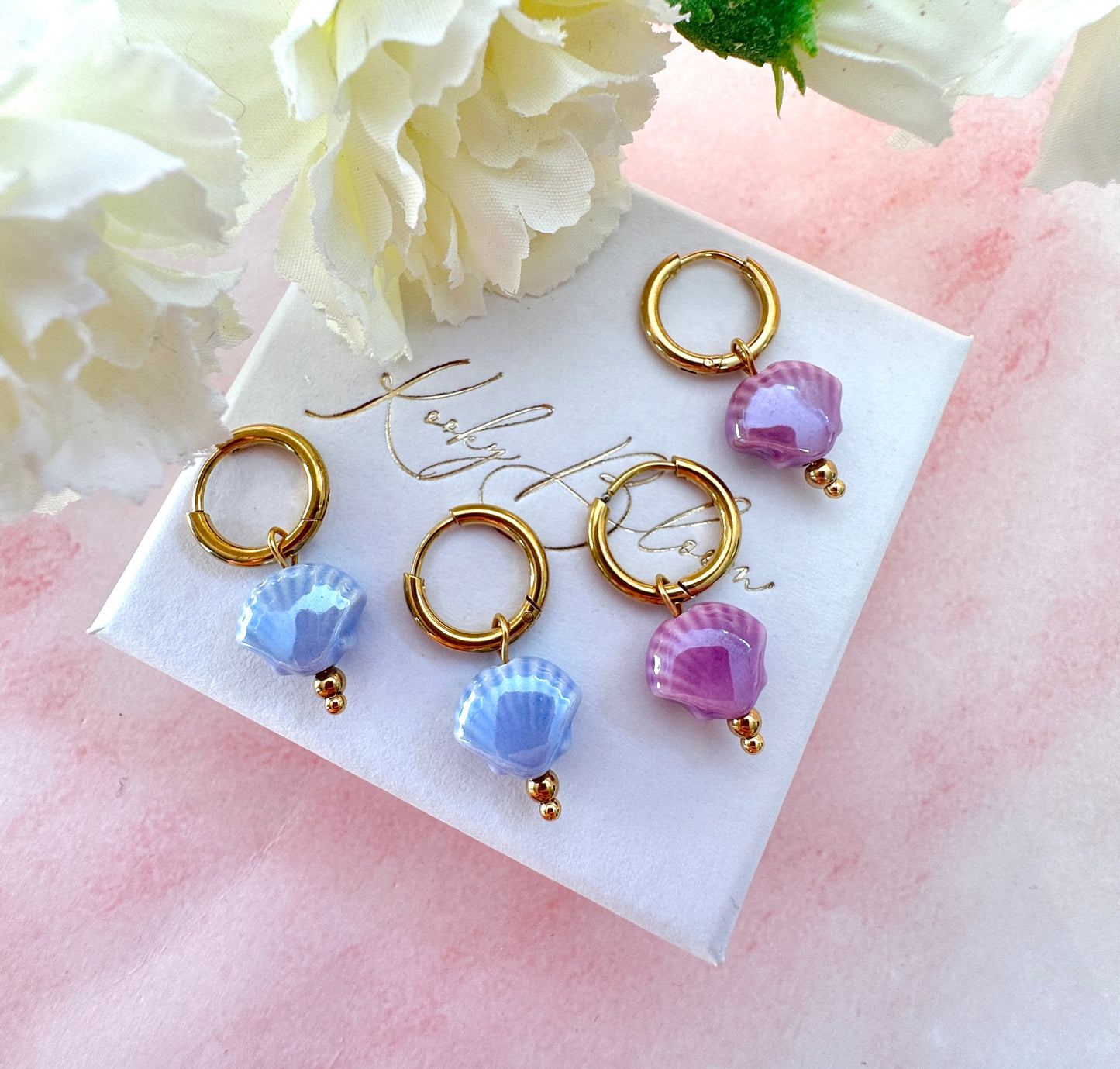 Gold ceramic seashell bead earrings.