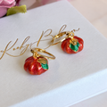 Gold metallic pumpkin huggie earrings.