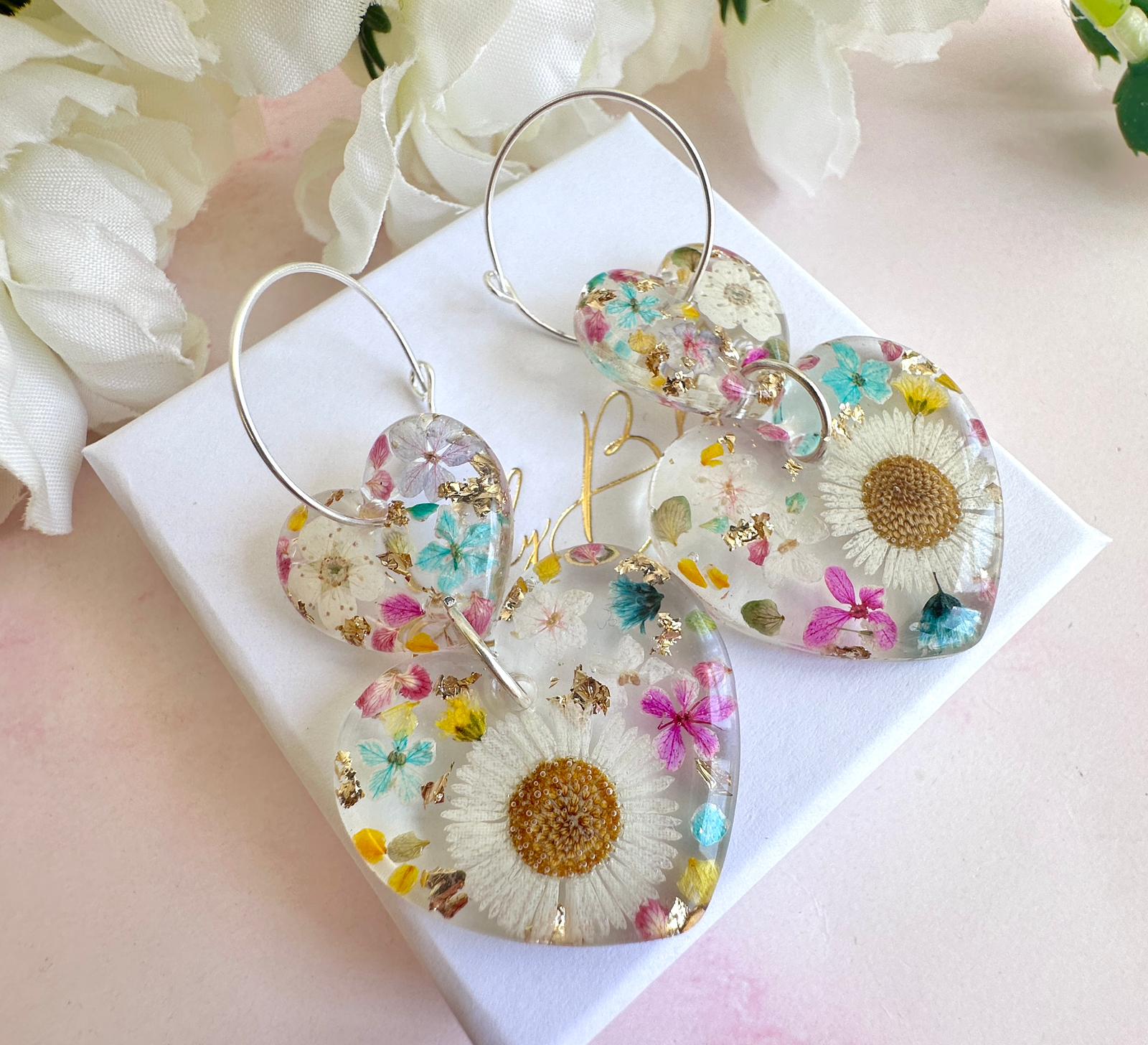 Daisy confetti double heart drop hoop earrings.