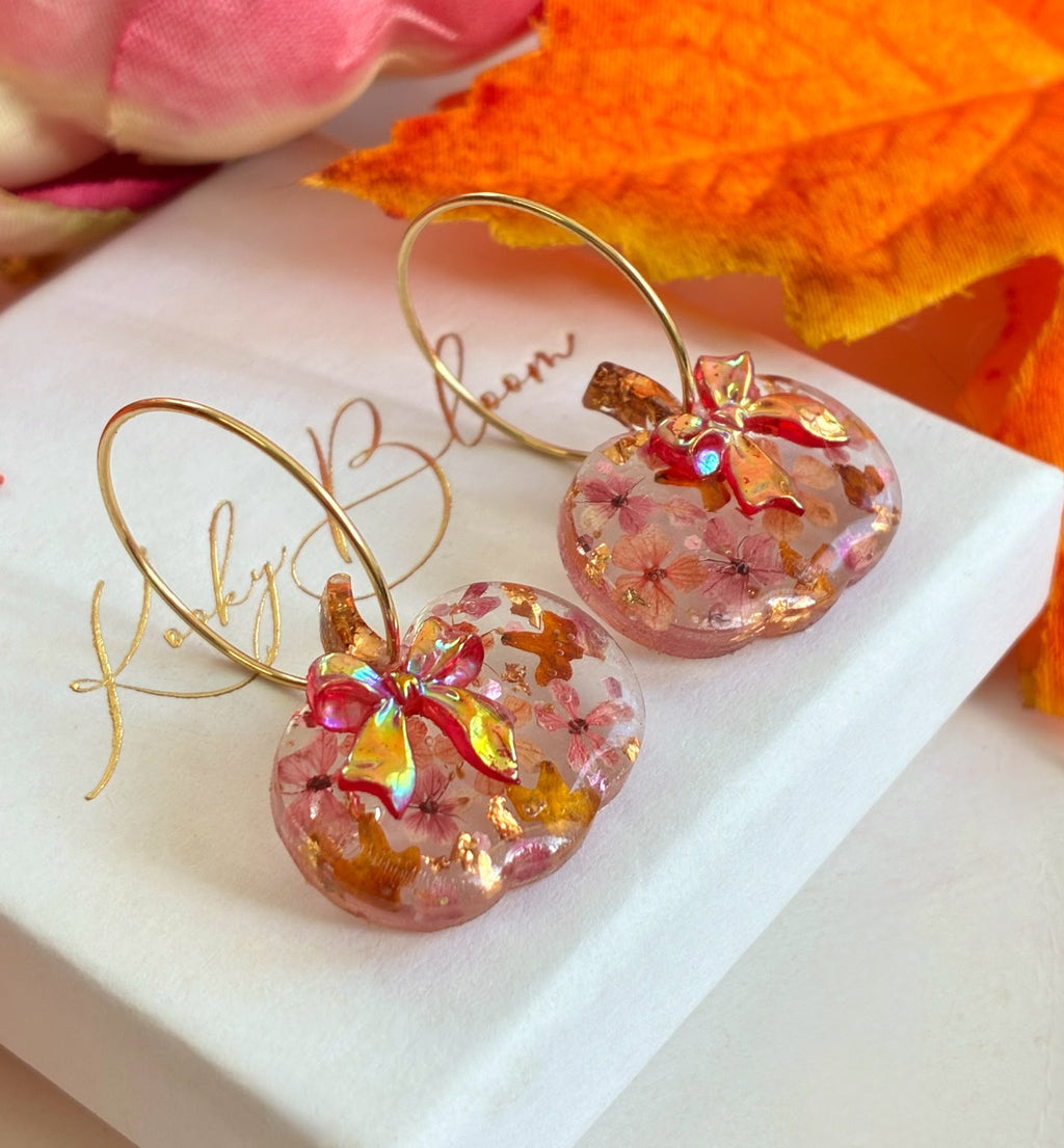 Rosie Bloom Bow Pumpkin hoop earrings.