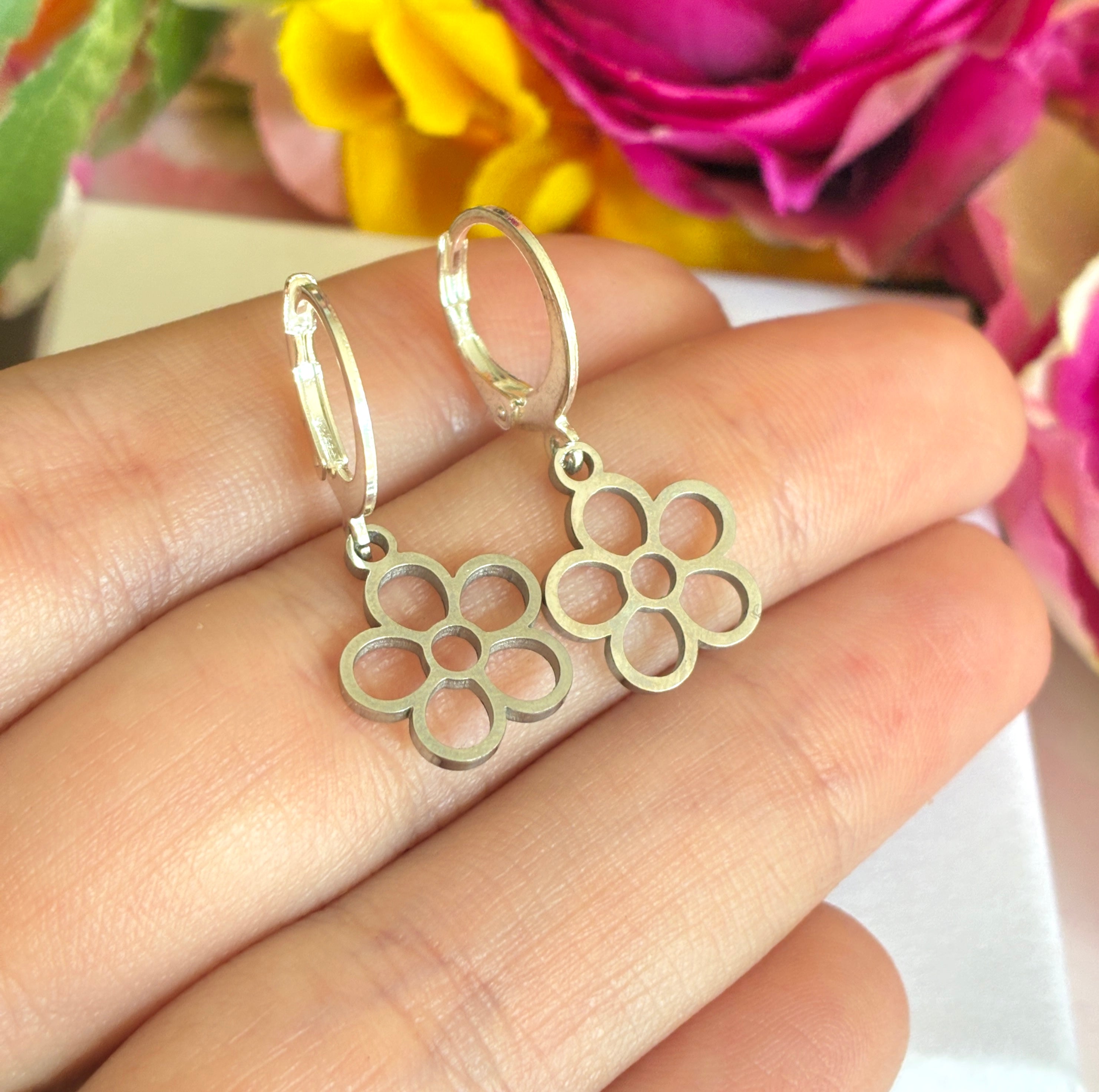 Silver tiny hollow flower huggie earrings.