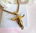 Gold longhorn necklace.