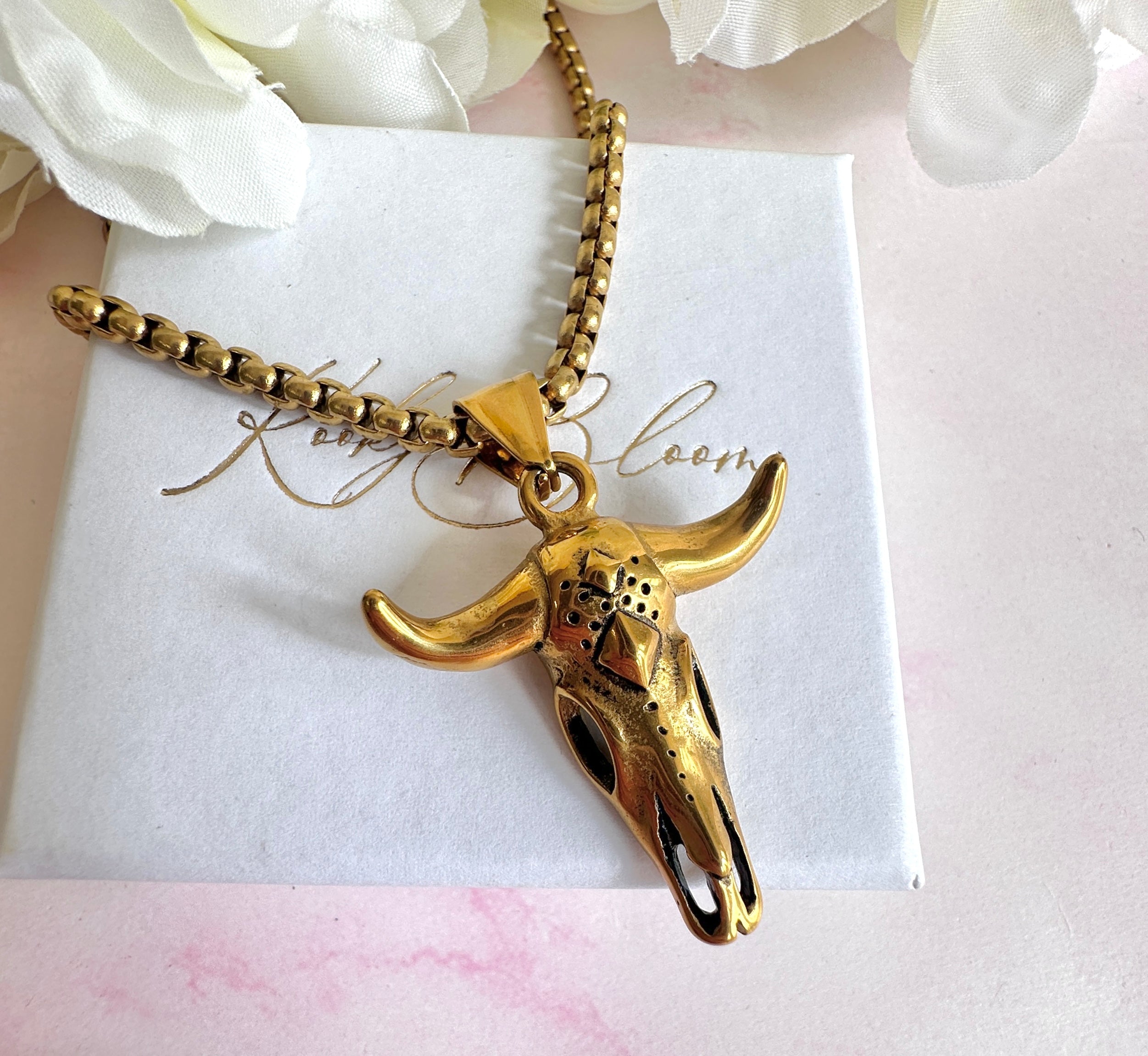 Gold longhorn necklace.
