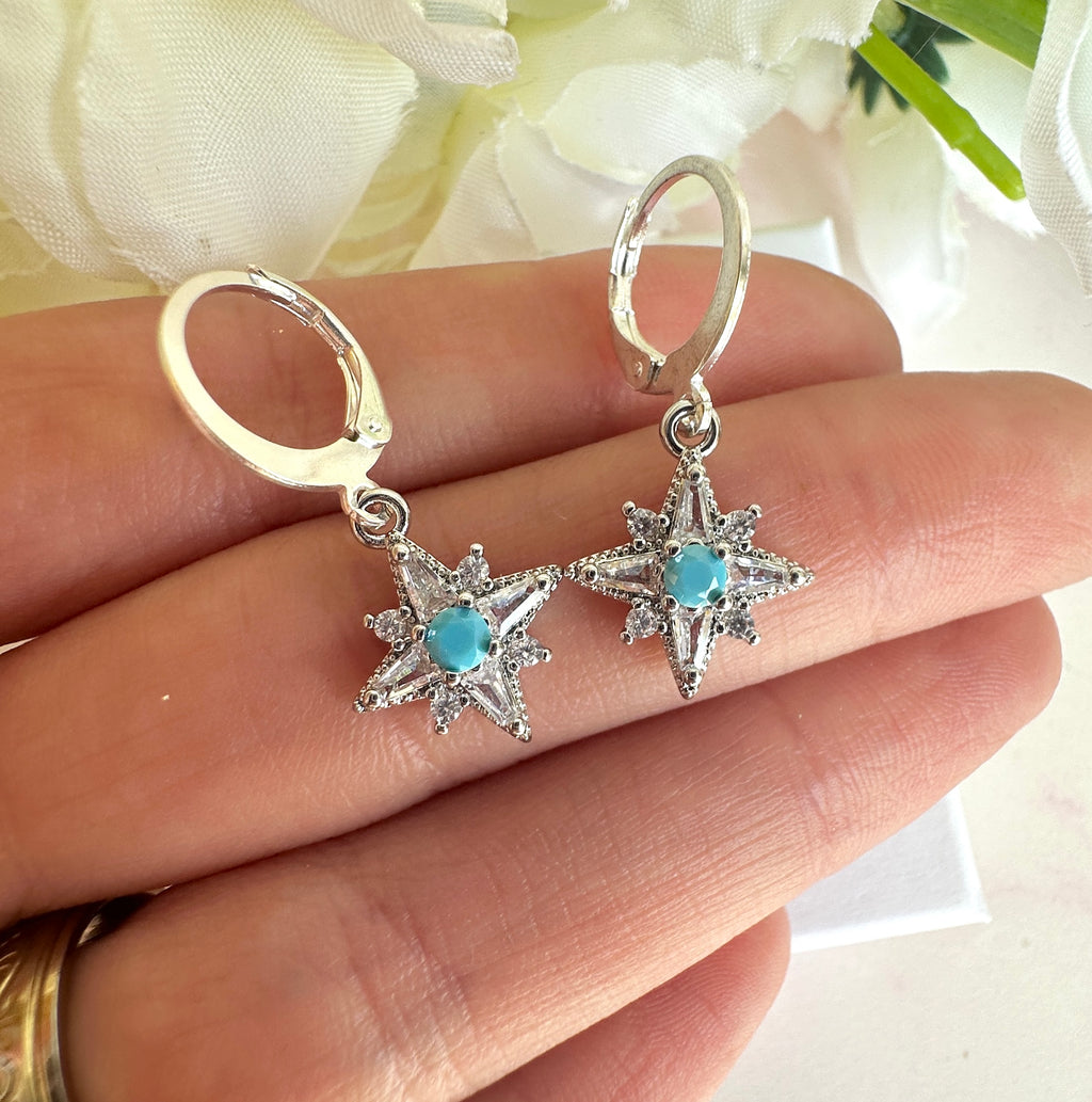 Silver tiny Cz Blue stone Star huggie earrings.