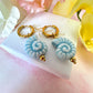 Blue ceramic seashell hoop earrings.